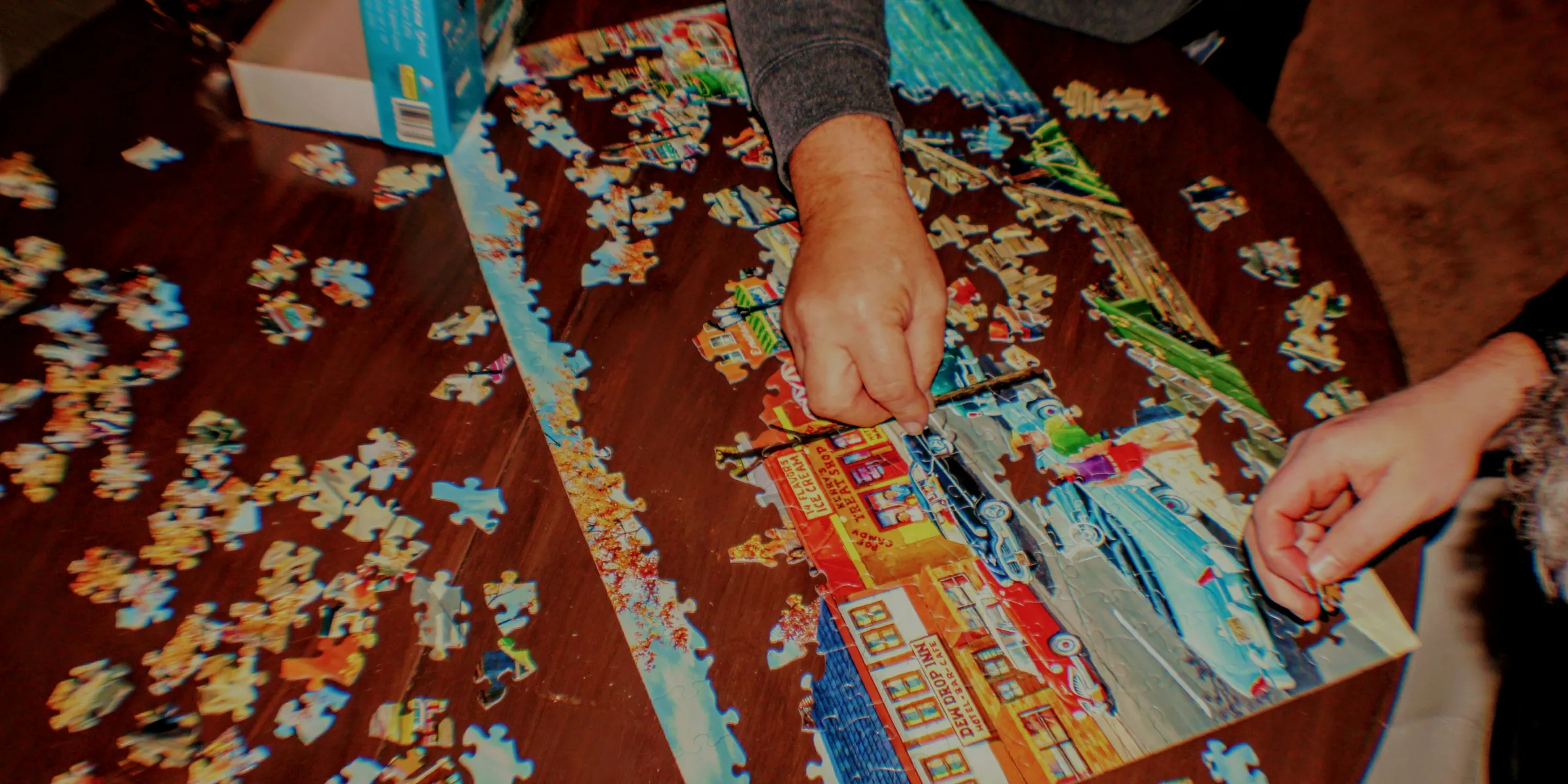 a person putting together a puzzle on a table