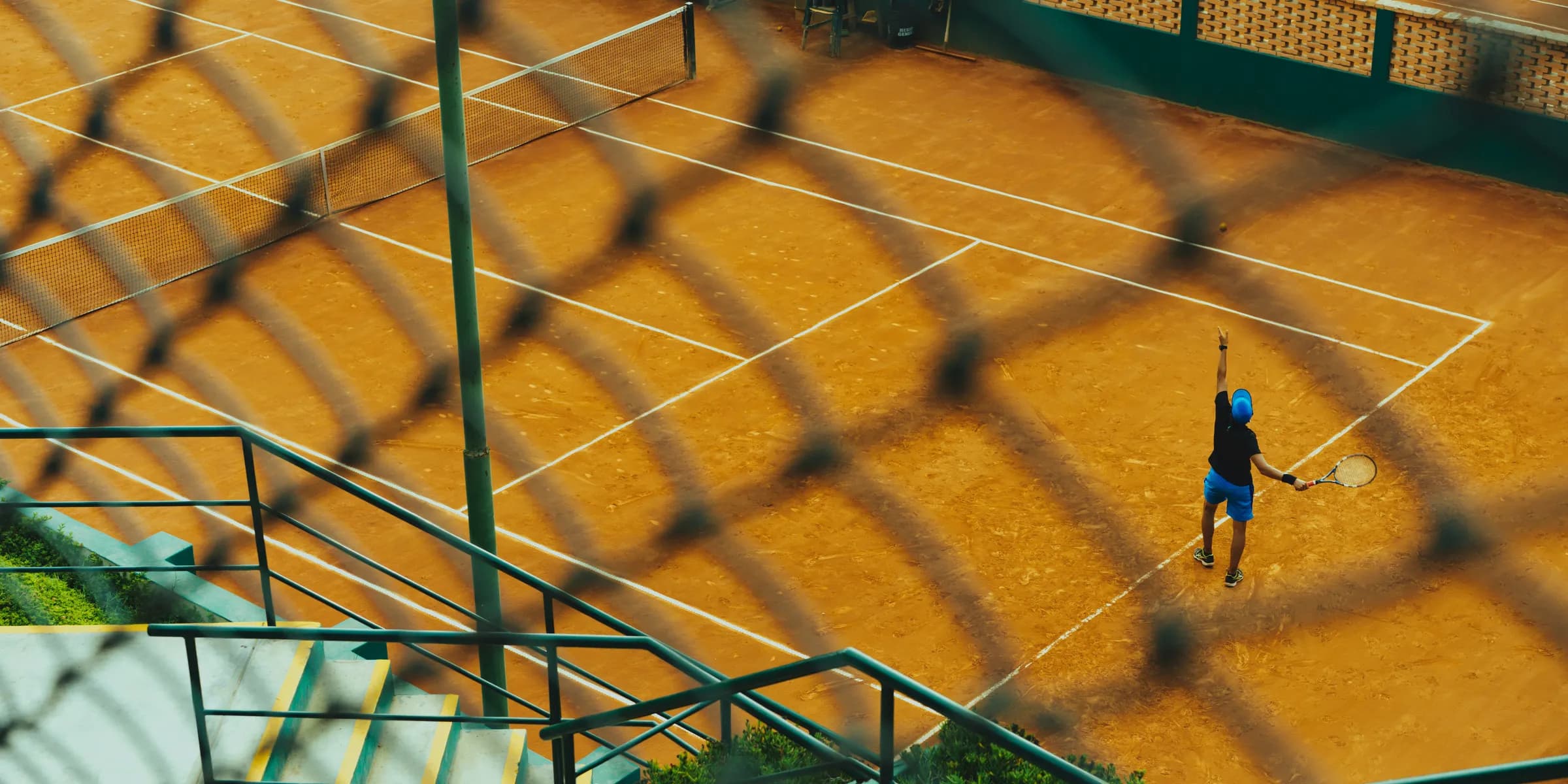 man playing tennis in court