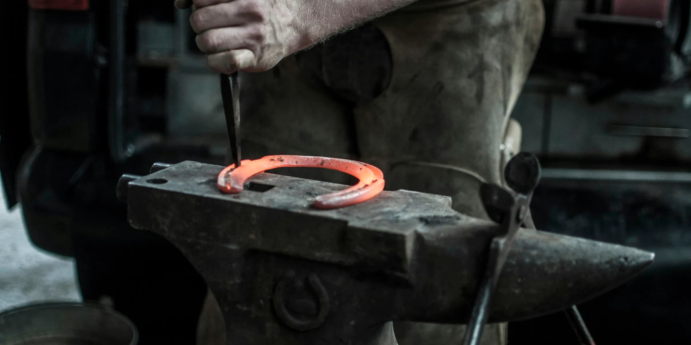 man forging horseshoe