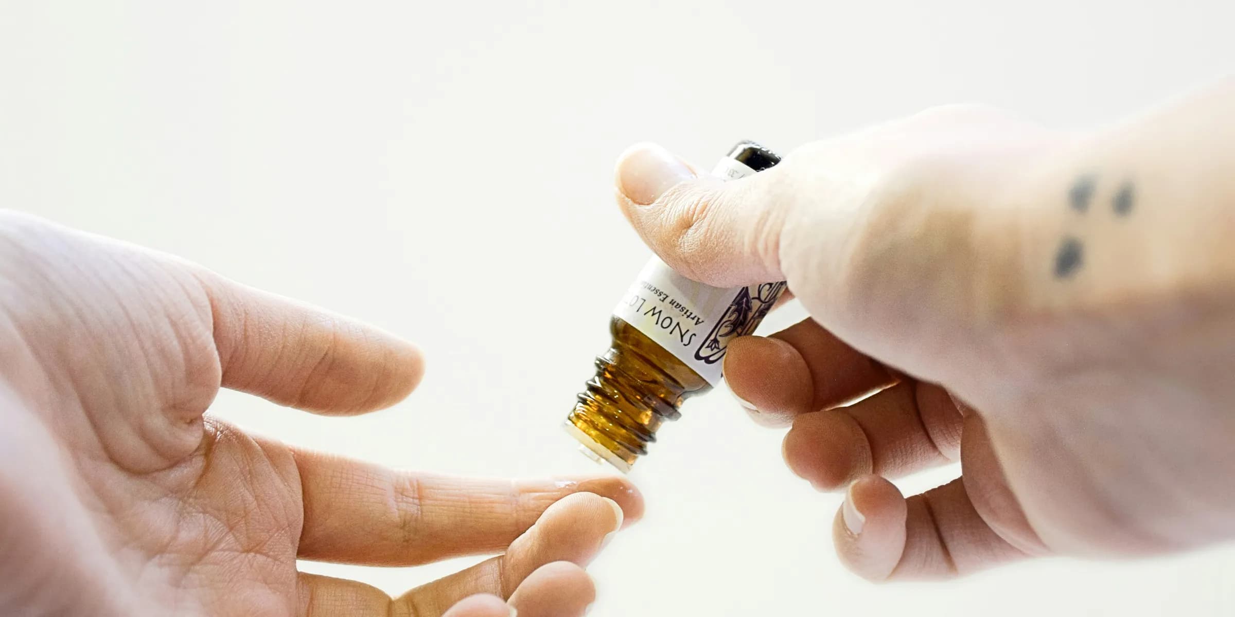 person holding brown glass bottle