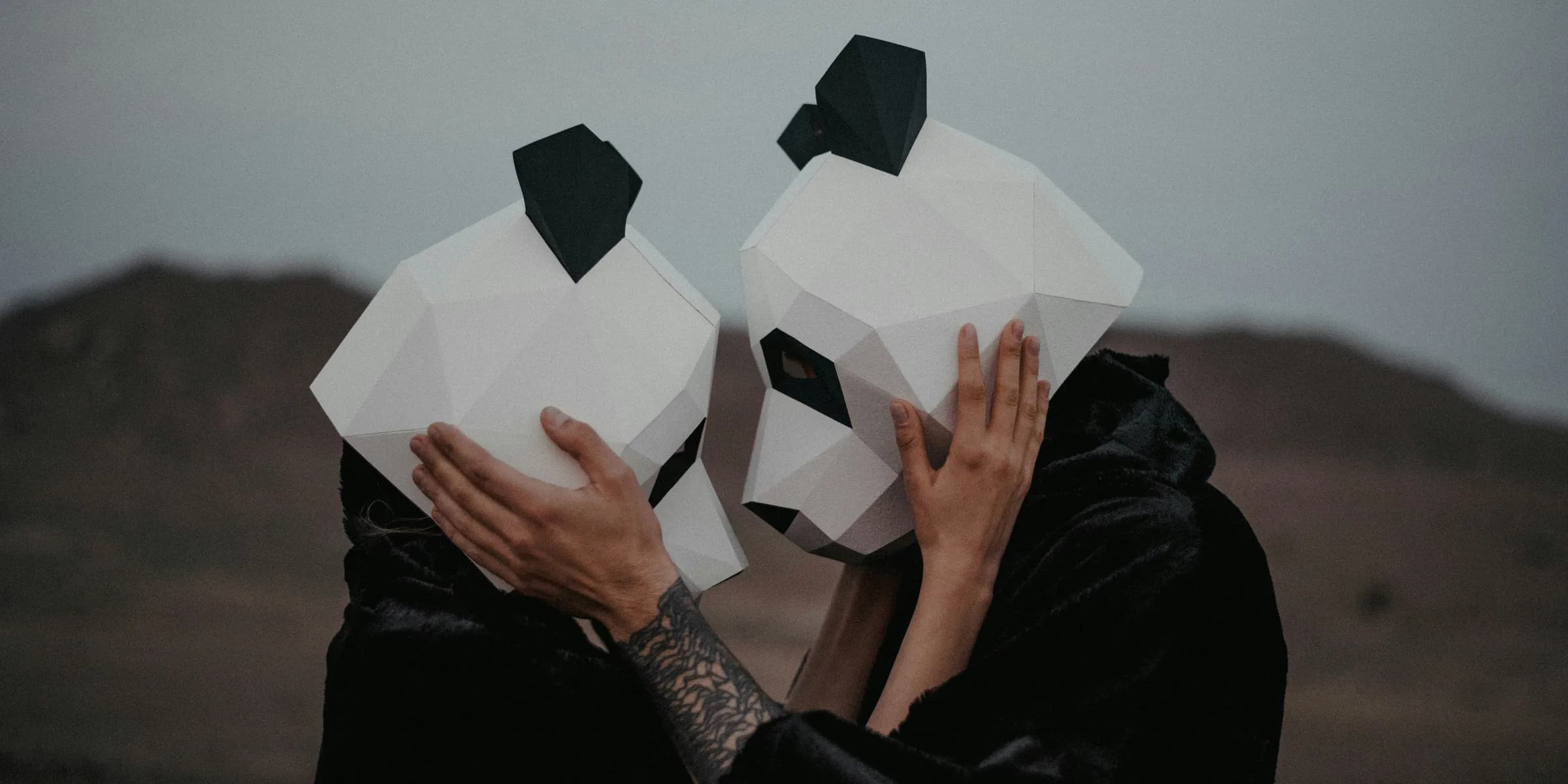 a man and a woman with paper masks covering their faces