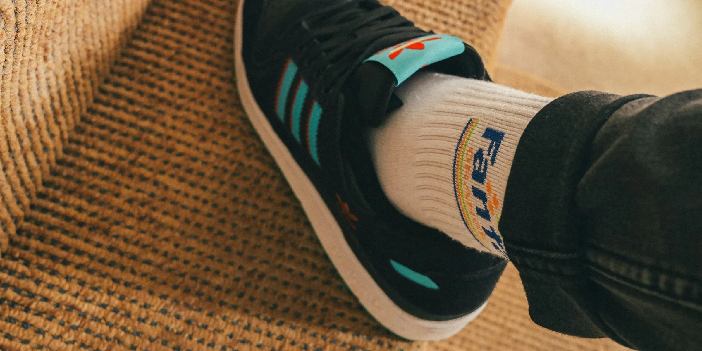 a person wearing a pair of black and blue sneakers