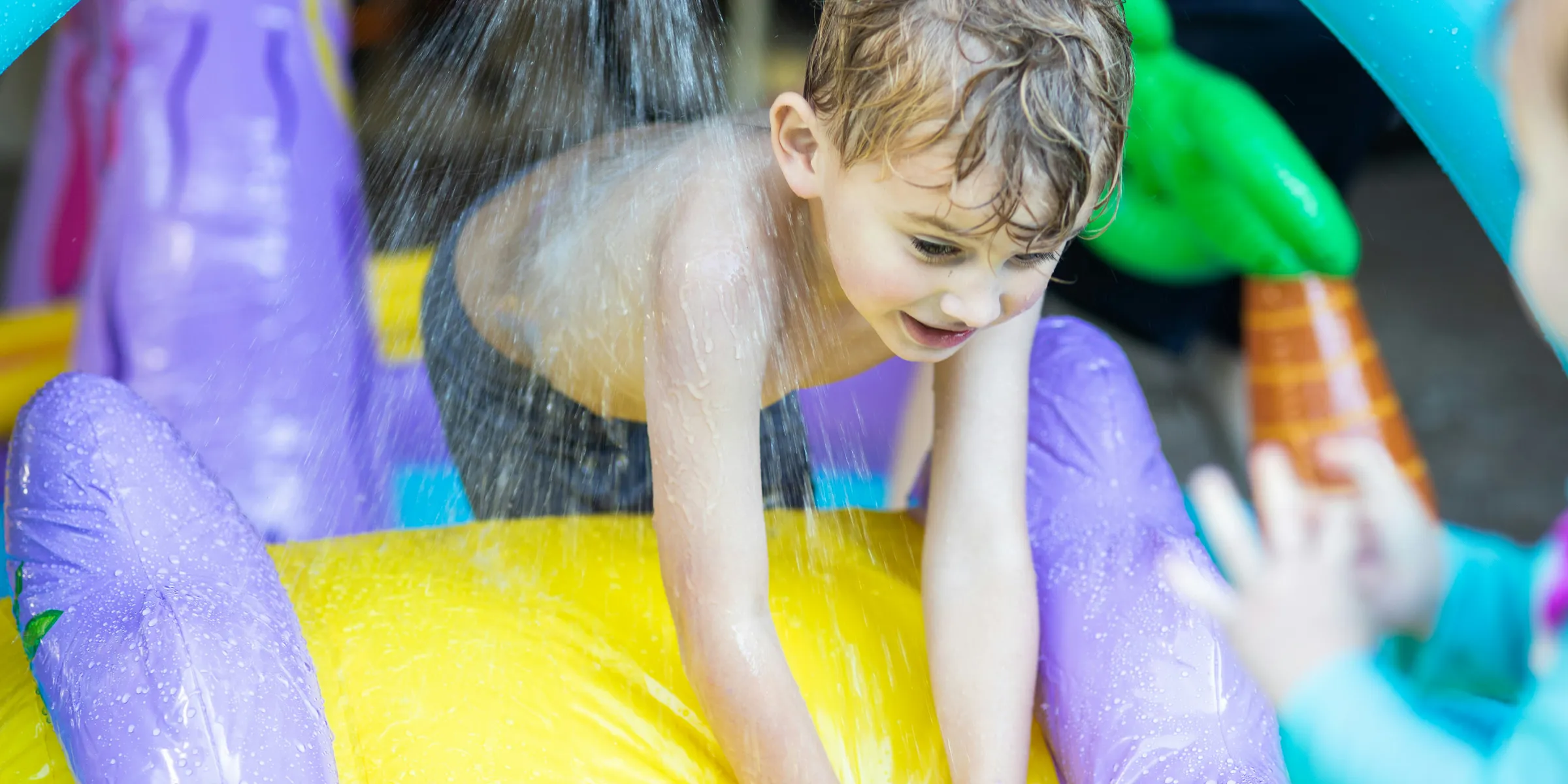 girl in pink shirt on yellow inflatable ring