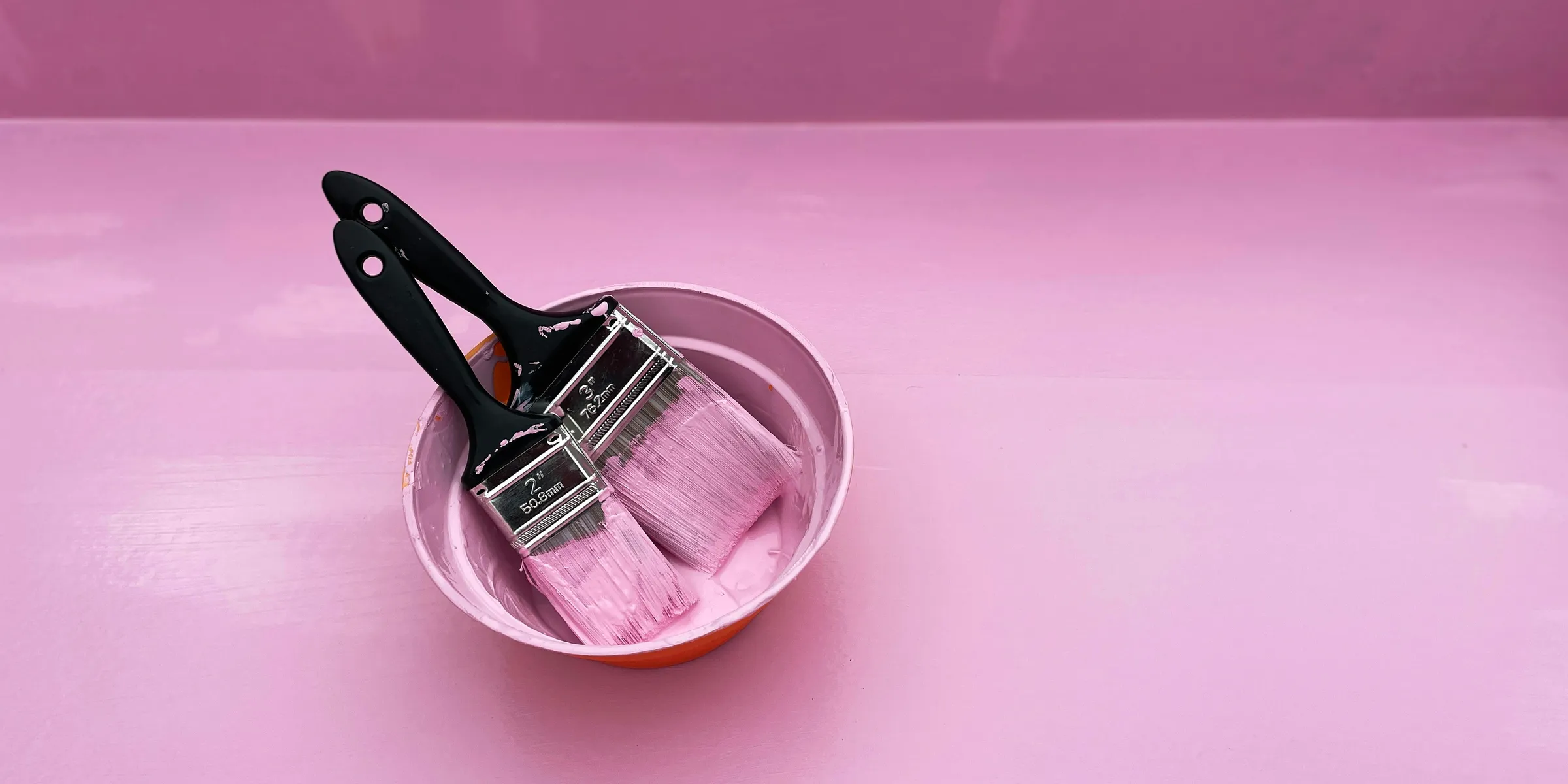 stainless steel cooking pot on pink round plate