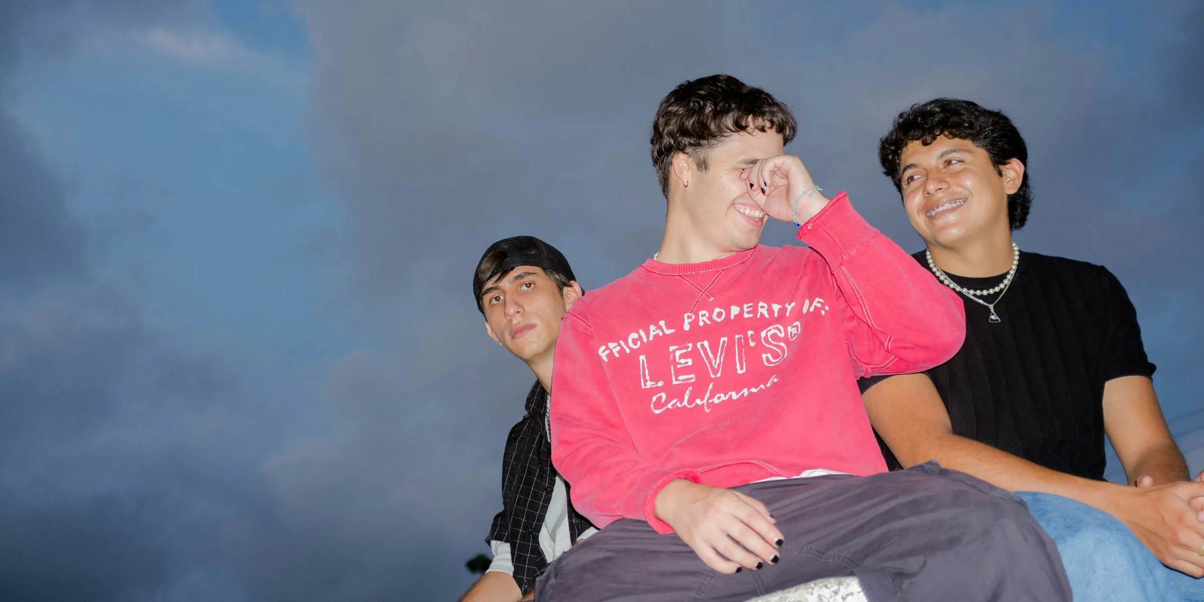 a group of young men sitting next to each other