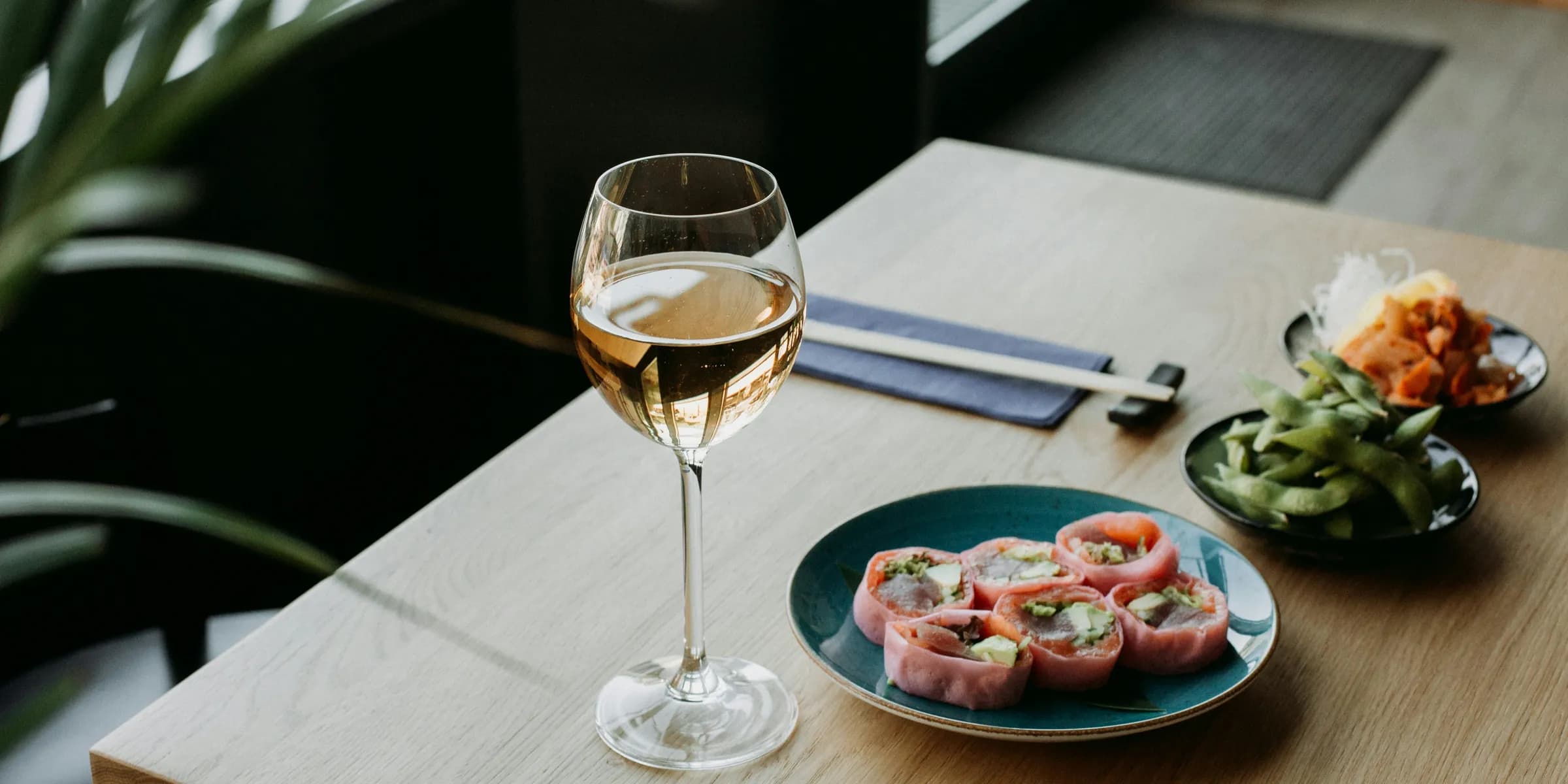 a plate of food and a glass of wine on a table