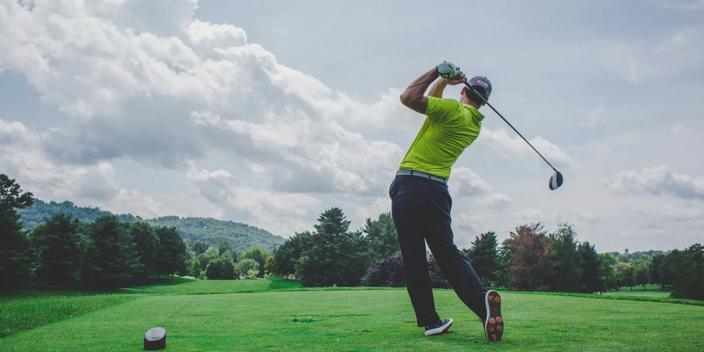 person golfing in a green golf course