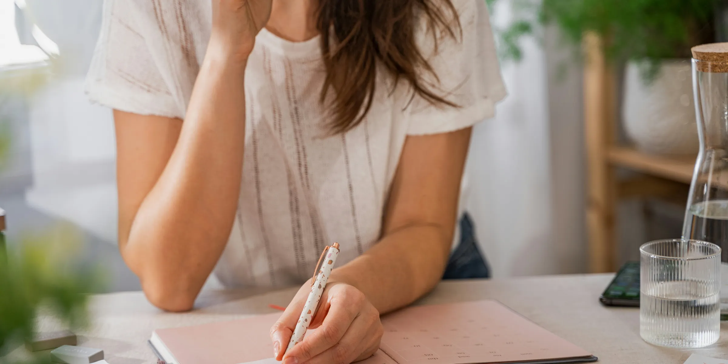 a woman writing on a piece of paper