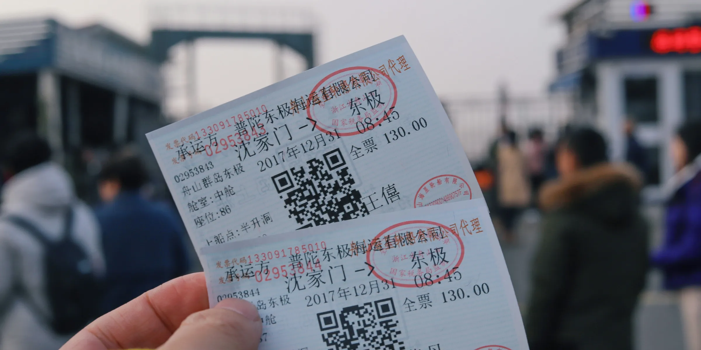 person holding two white tickets