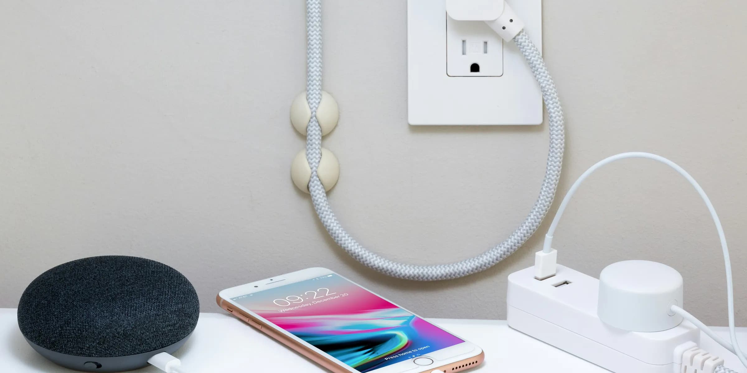 a cell phone plugged in to a wall charger