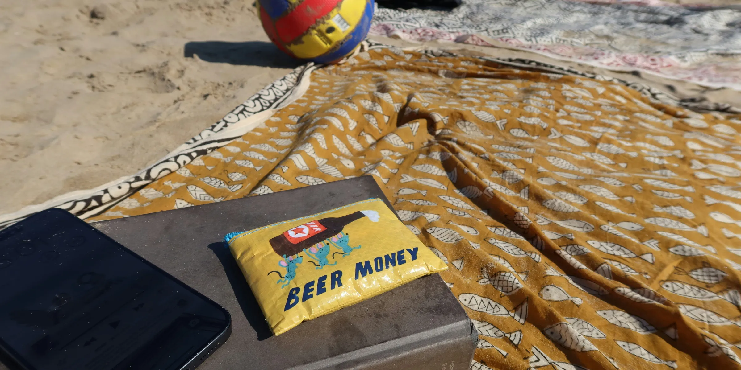 Beach day with a volleyball and beer money.