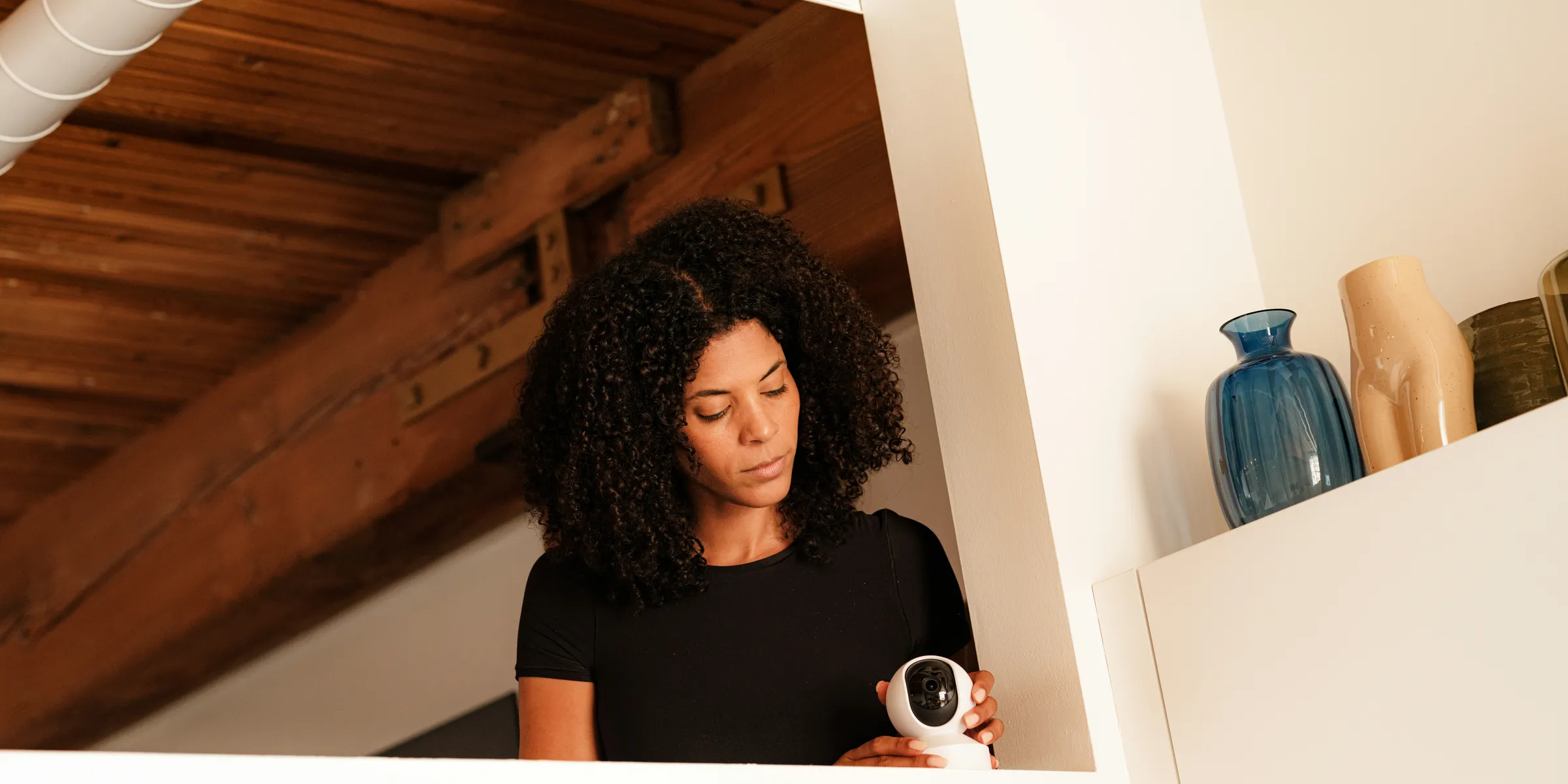 A woman standing in a room holding a camera
