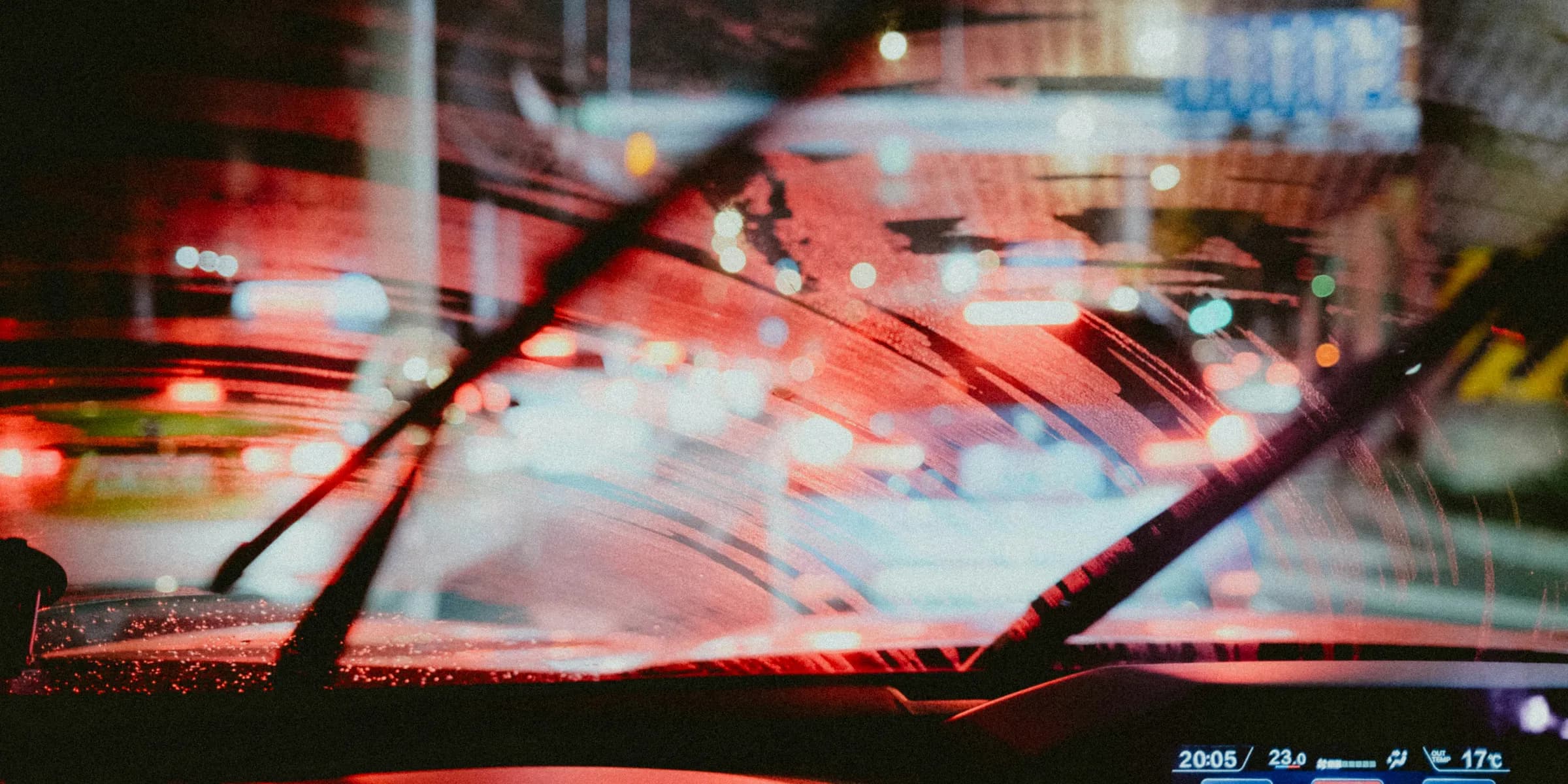 Driving in the rain with windshield wipers on.