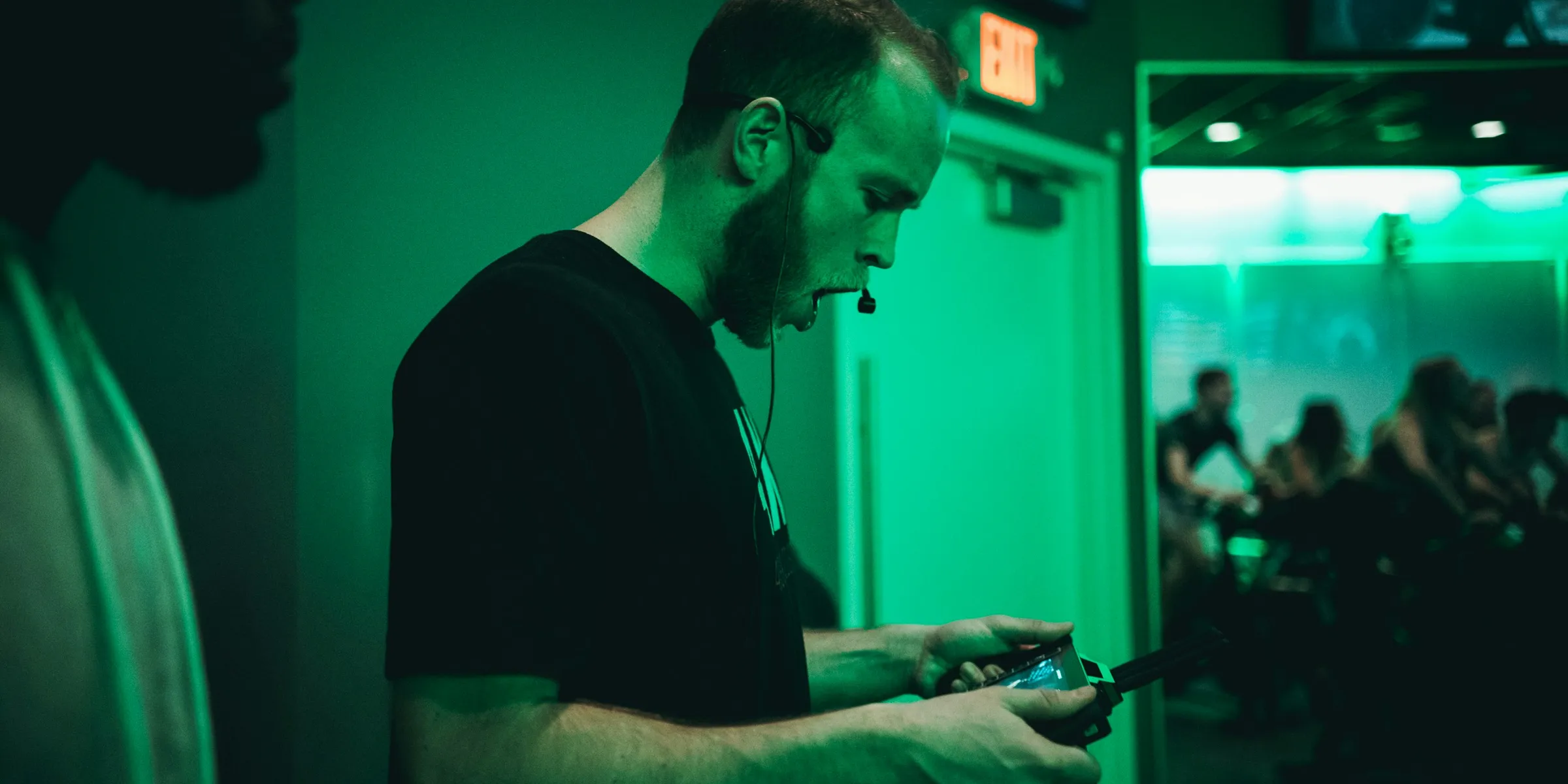 man holding game pad while shouting inside room
