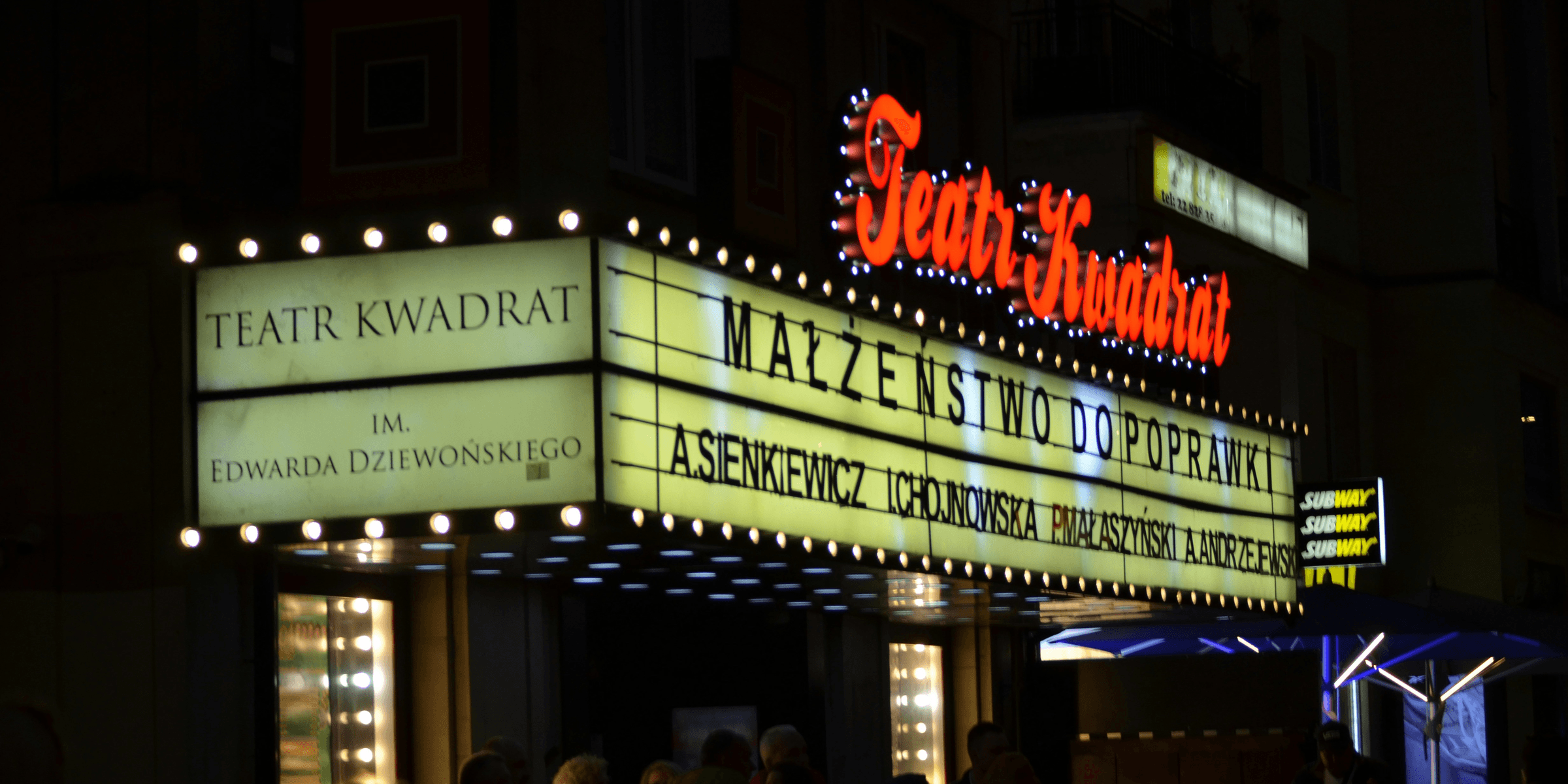 a theater marquee lit up at night
