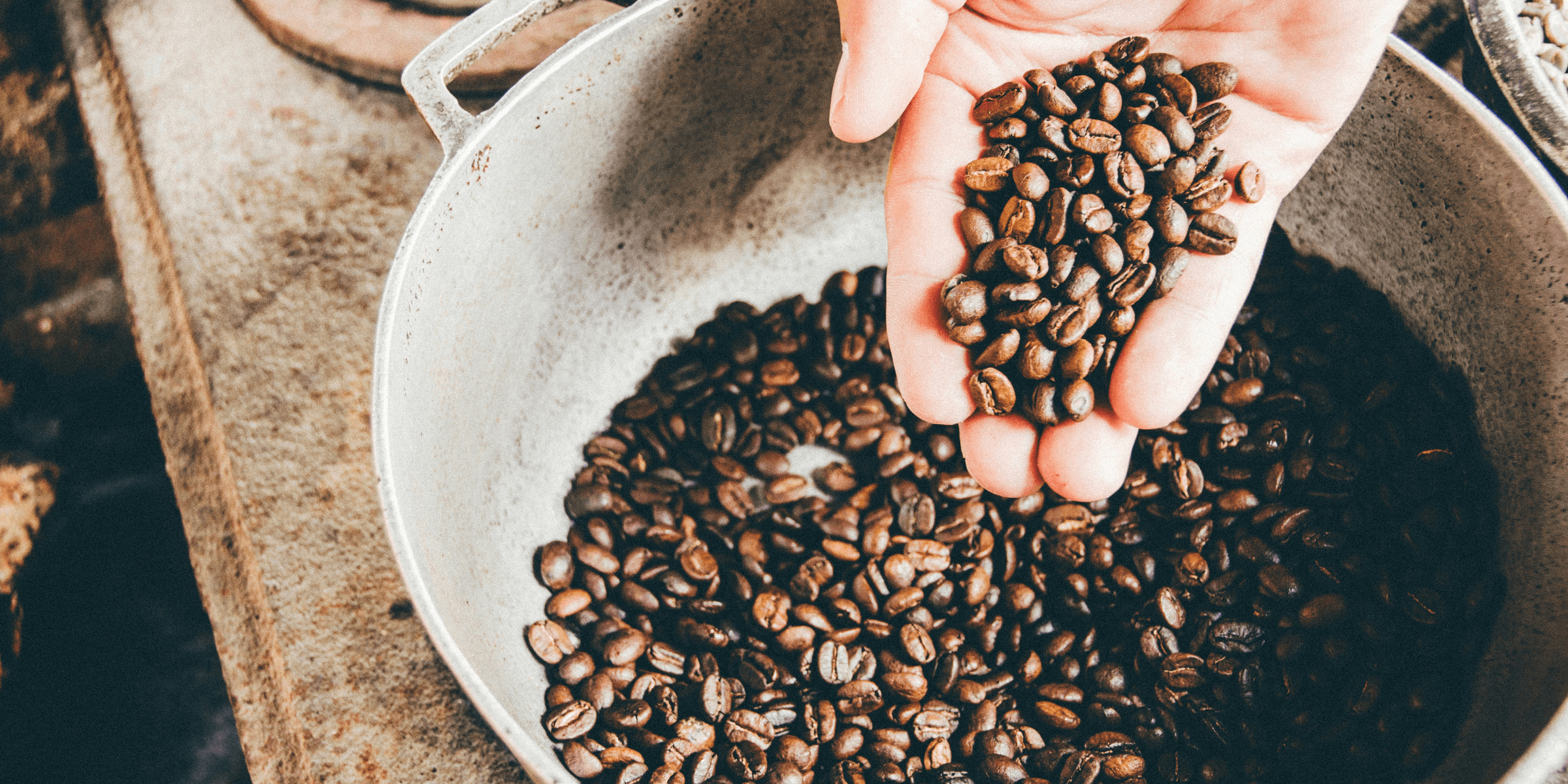 coffee beans on gray steel wok