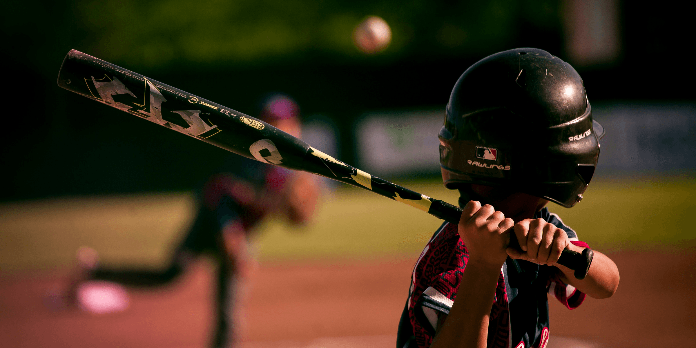 selective focus photography of person holding baseball bat