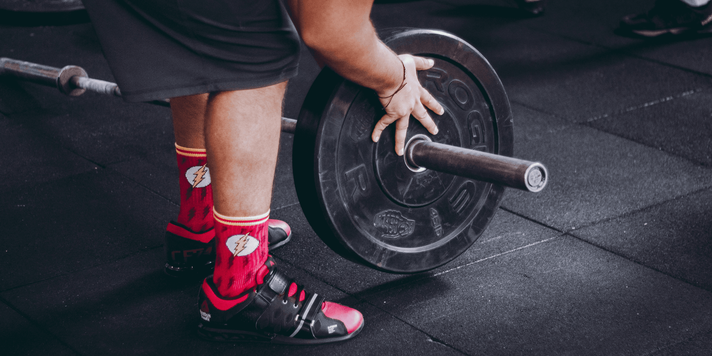 person arranging barbell plate