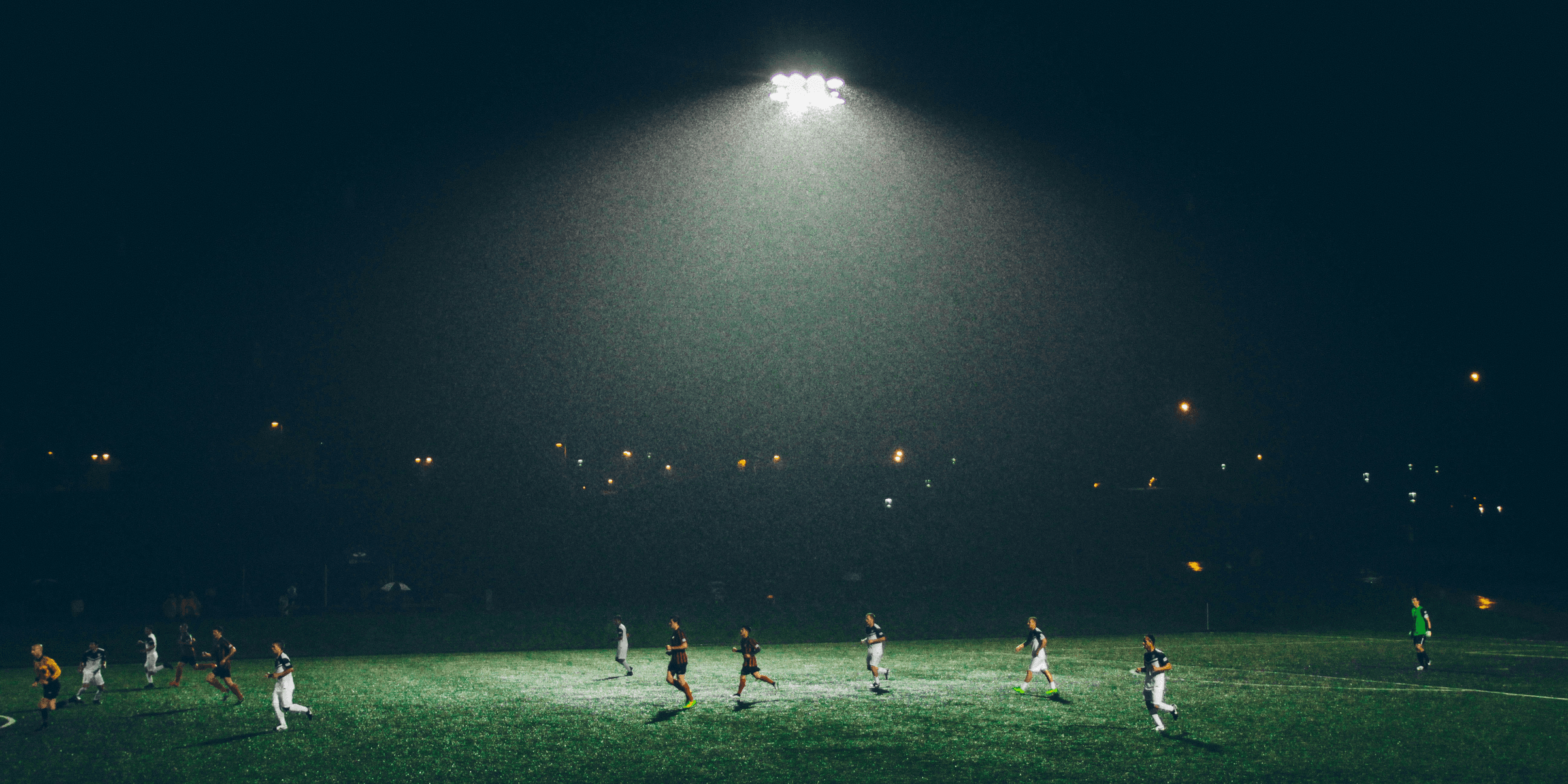 group of people playing soccer on soccer field