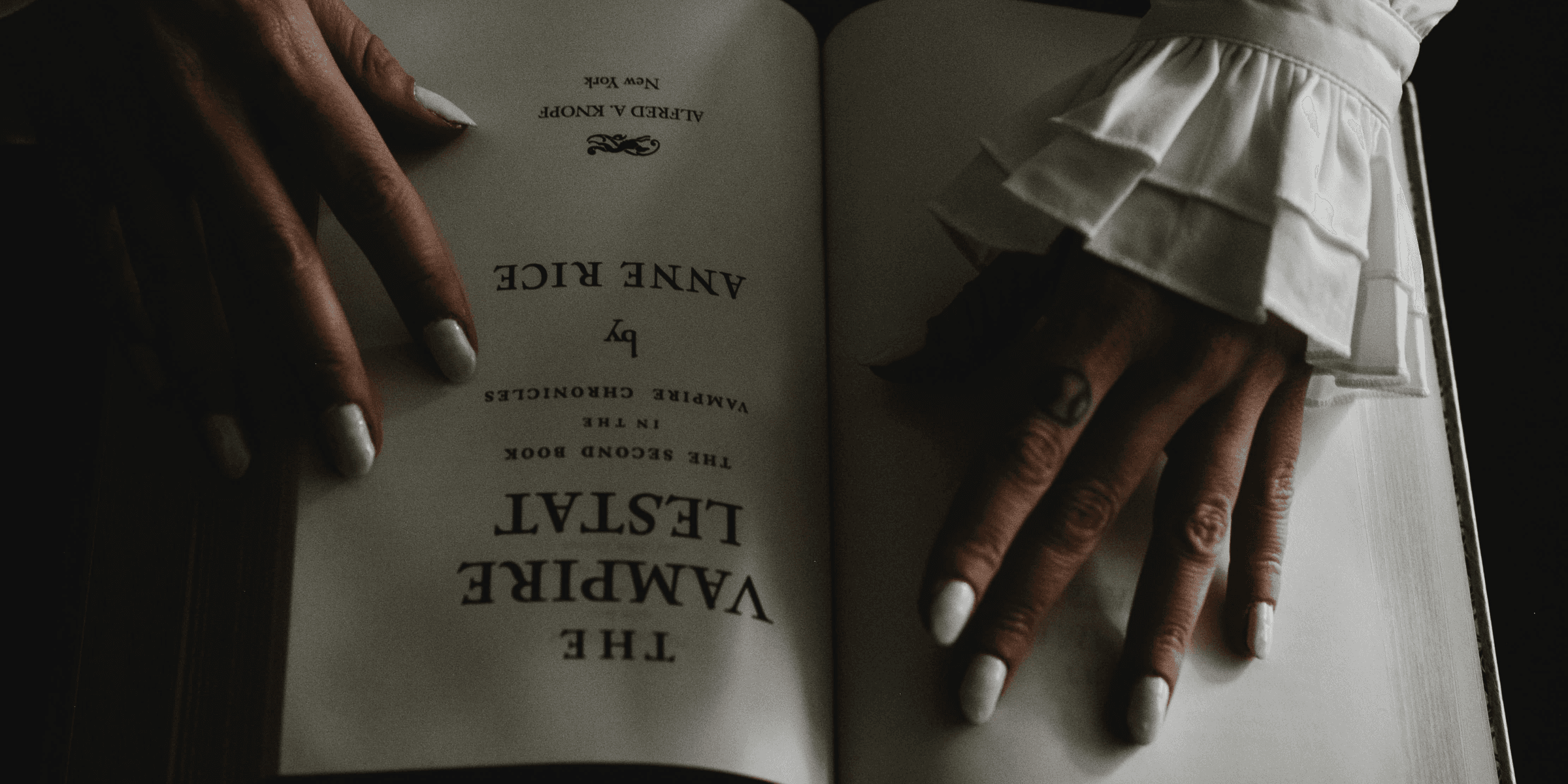a woman's hands holding an open book.