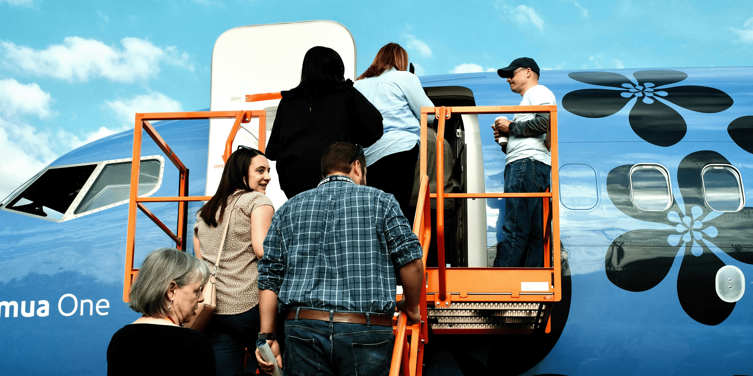 a group of people getting off of a plane.