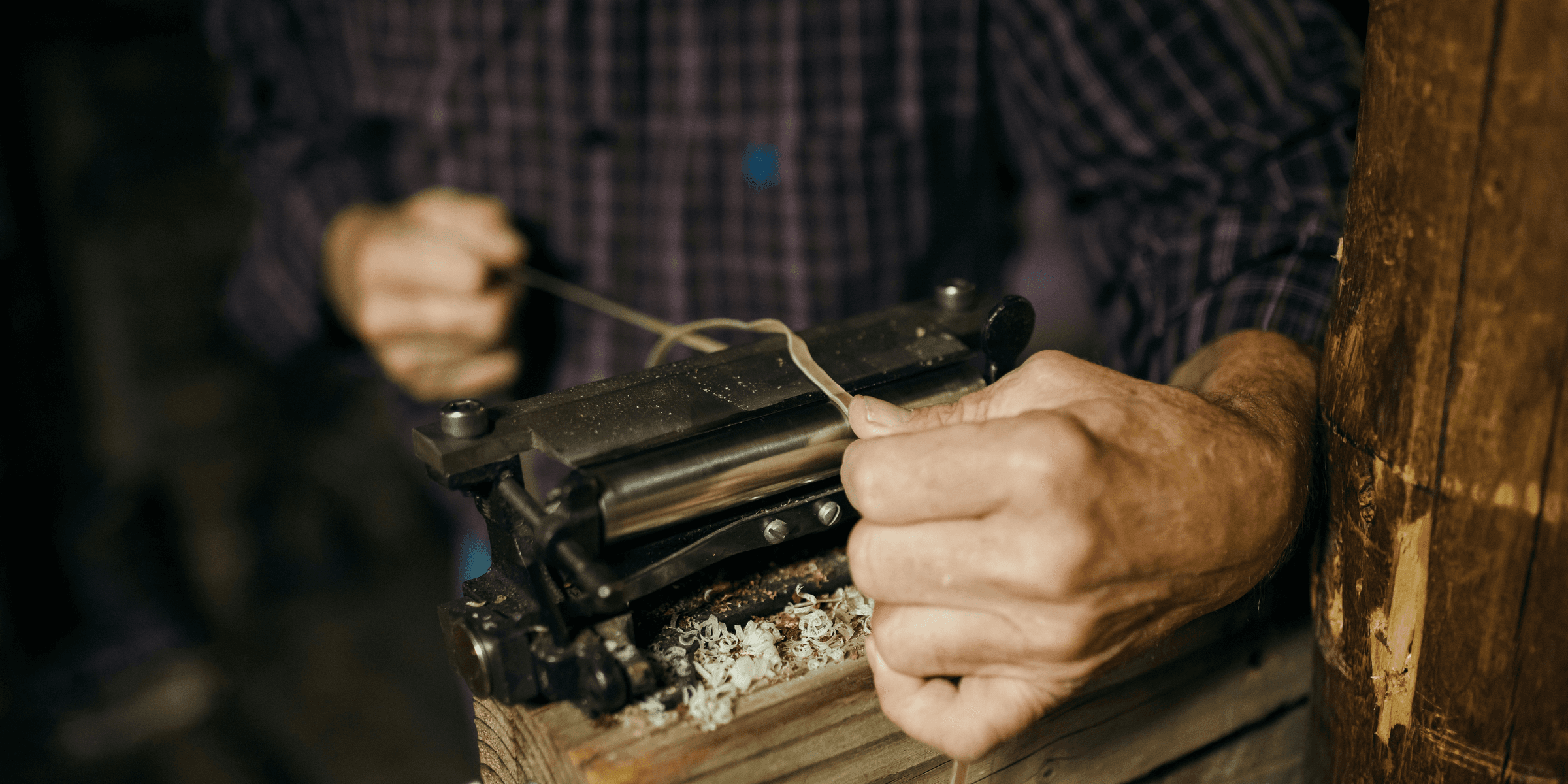 a man working on a piece of wood.
