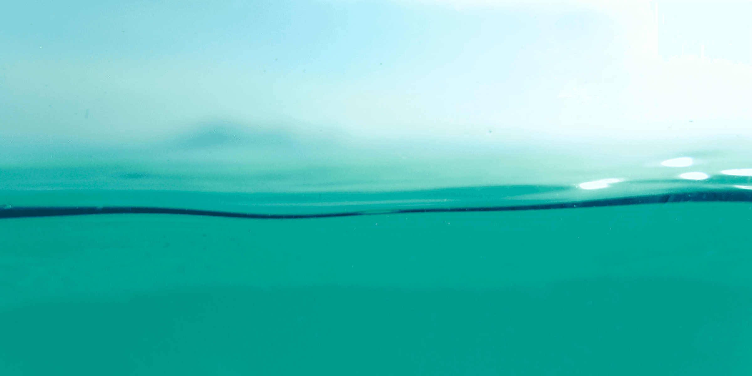 a view of the water from the bottom of a boat.
