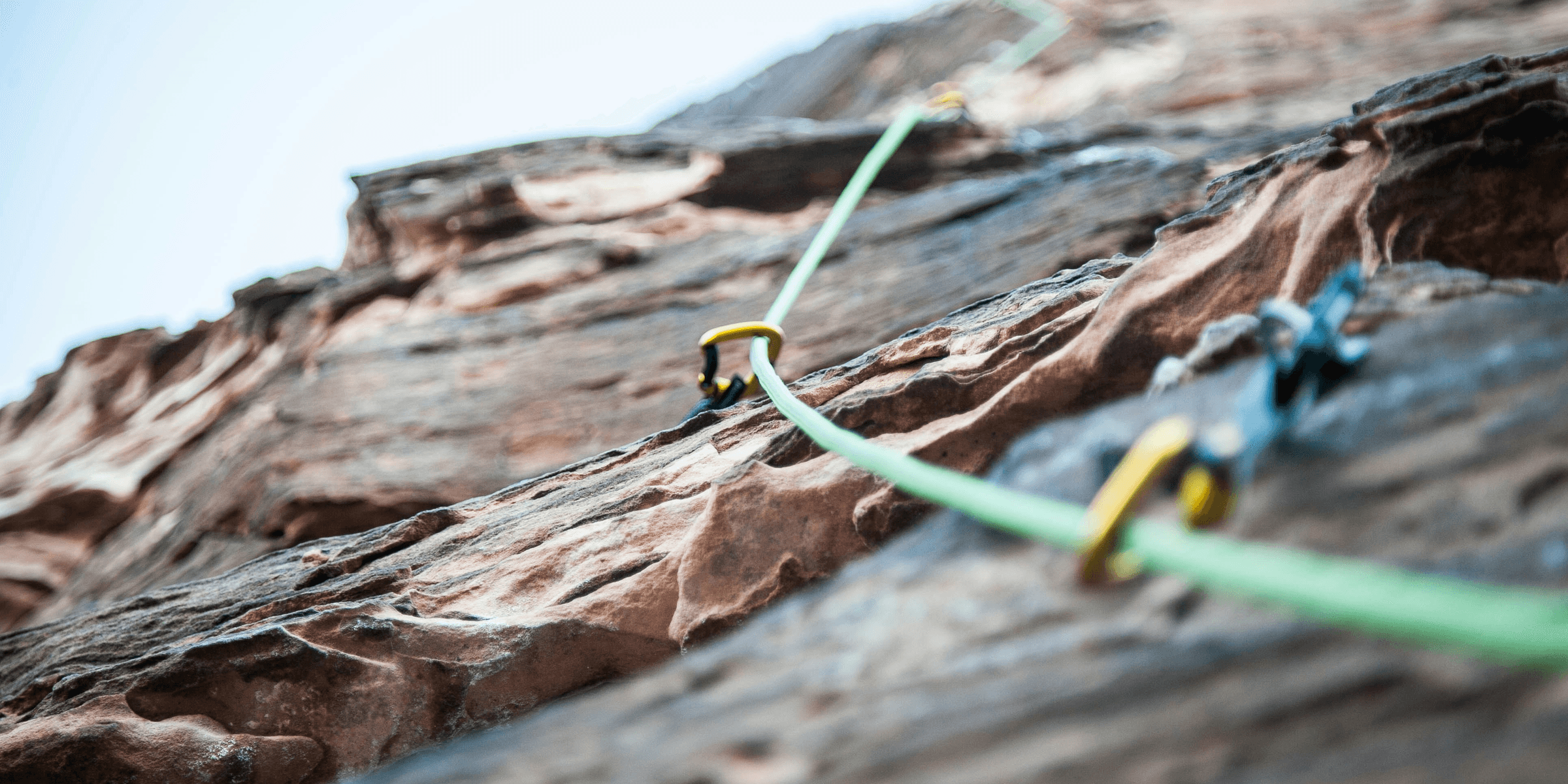 selective focus photo of green climbing safety rope.