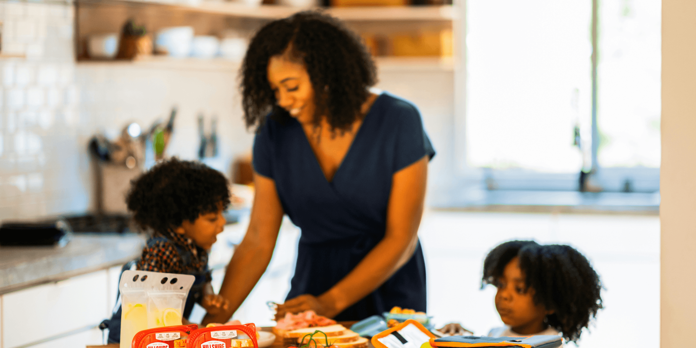 woman in black shirt holding orange and white plastic bottle.