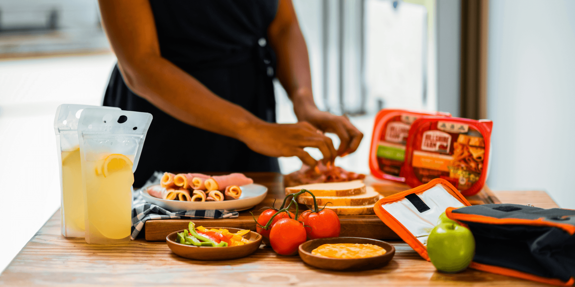 man in black polo shirt standing beside table with food.