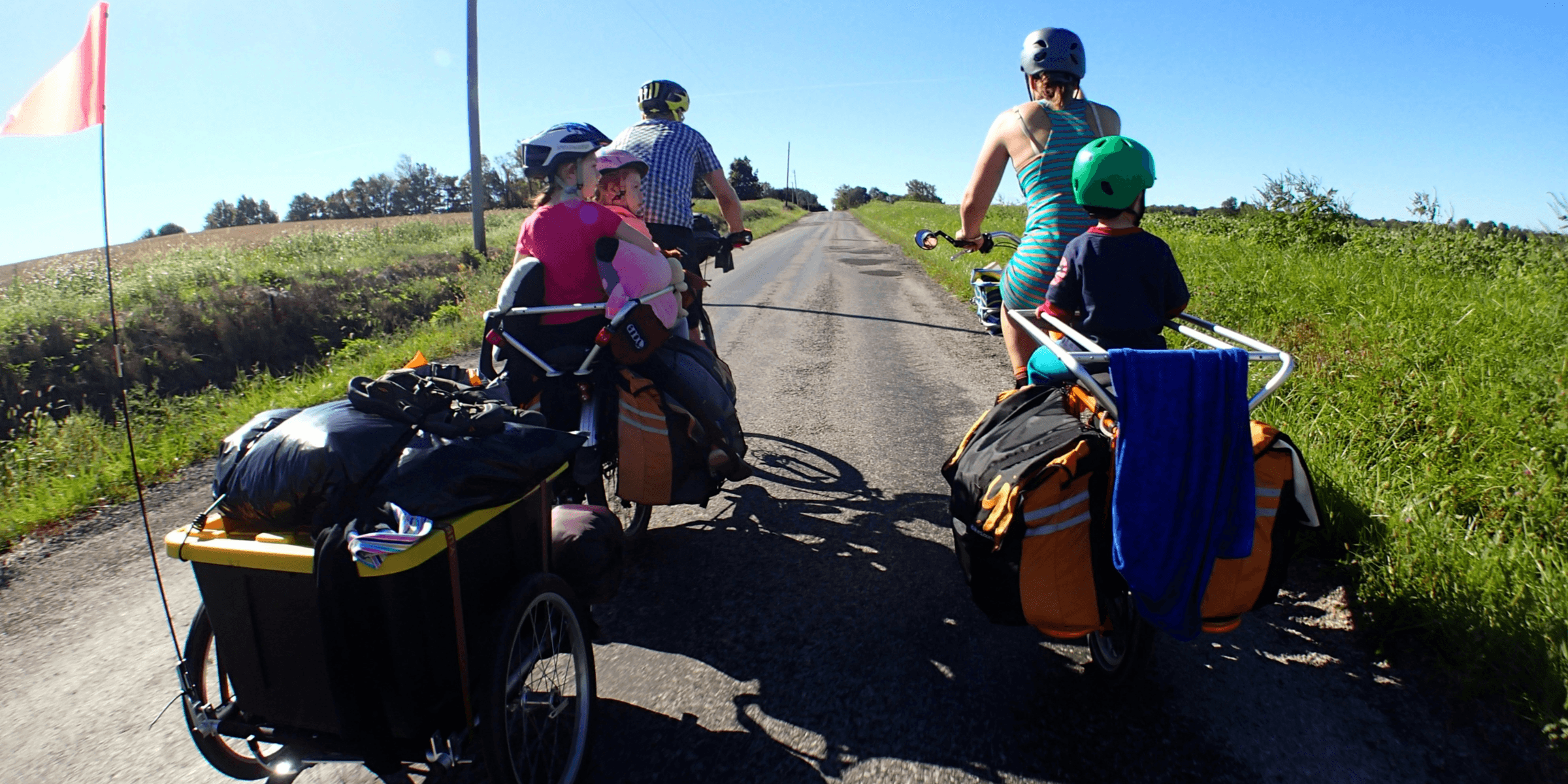 man in red shirt riding on black and yellow bicycle during daytime.