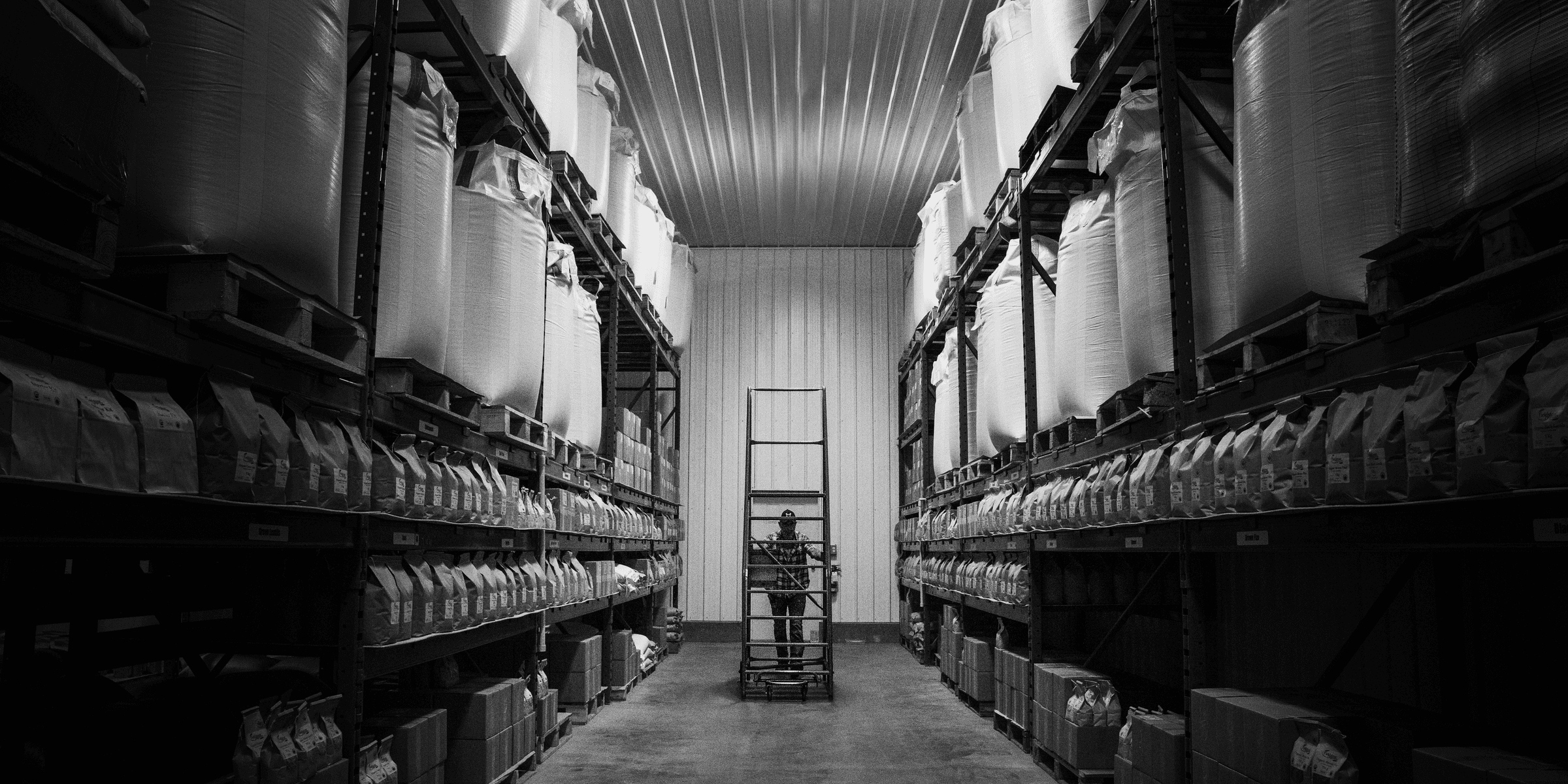 a warehouse filled with lots of shelves filled with boxes.
