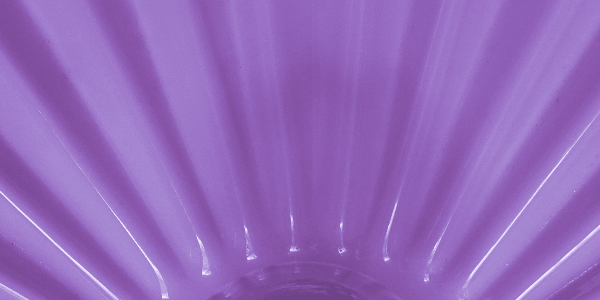 purple plastic container on brown wooden table.