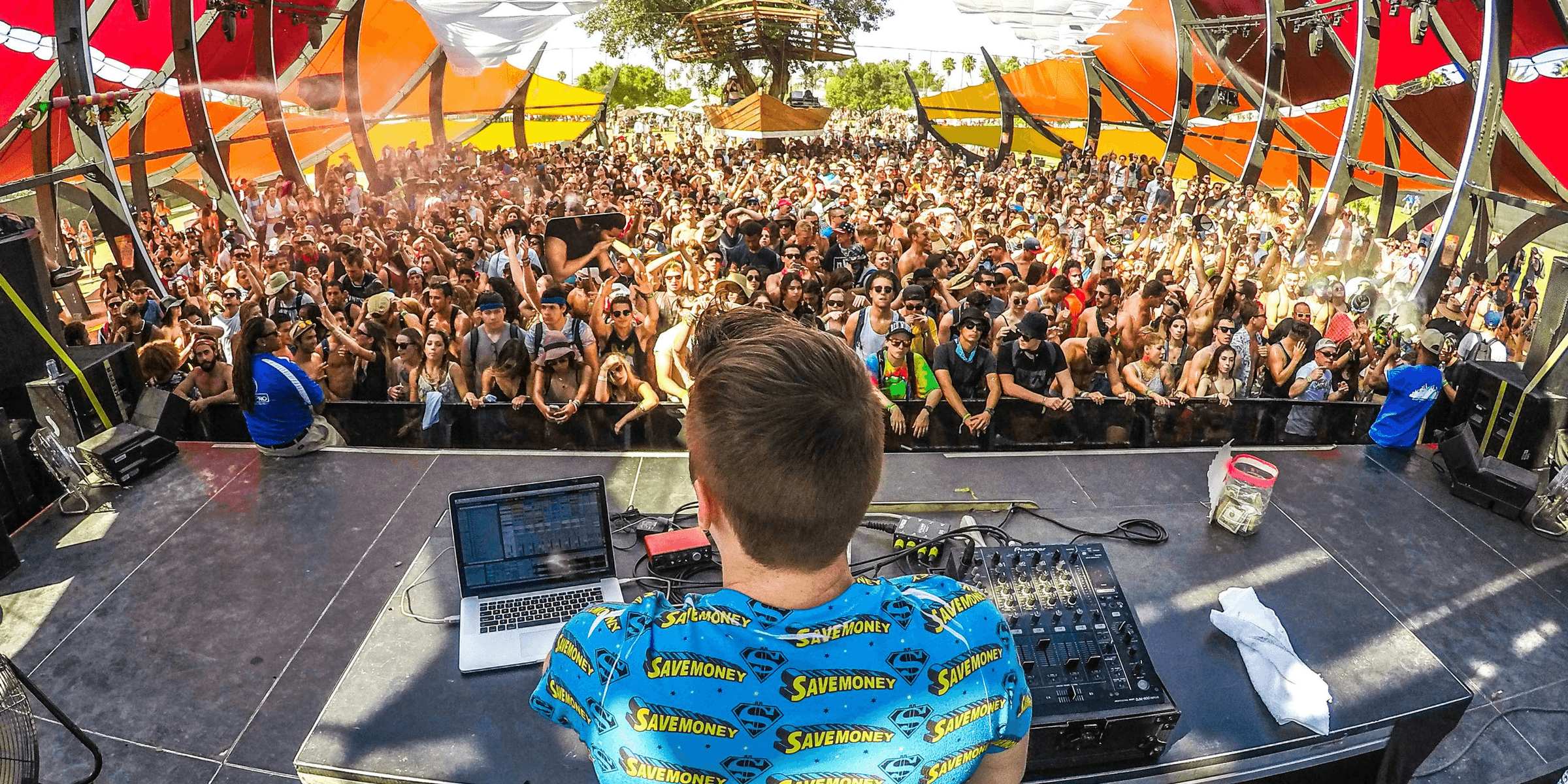 DJ on stage in front of audience.