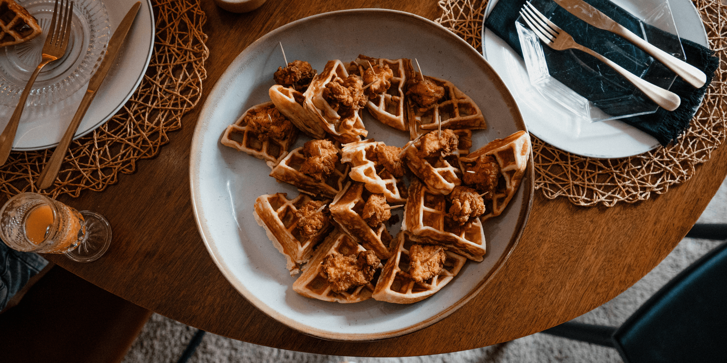 a plate of chicken and waffles on a table.