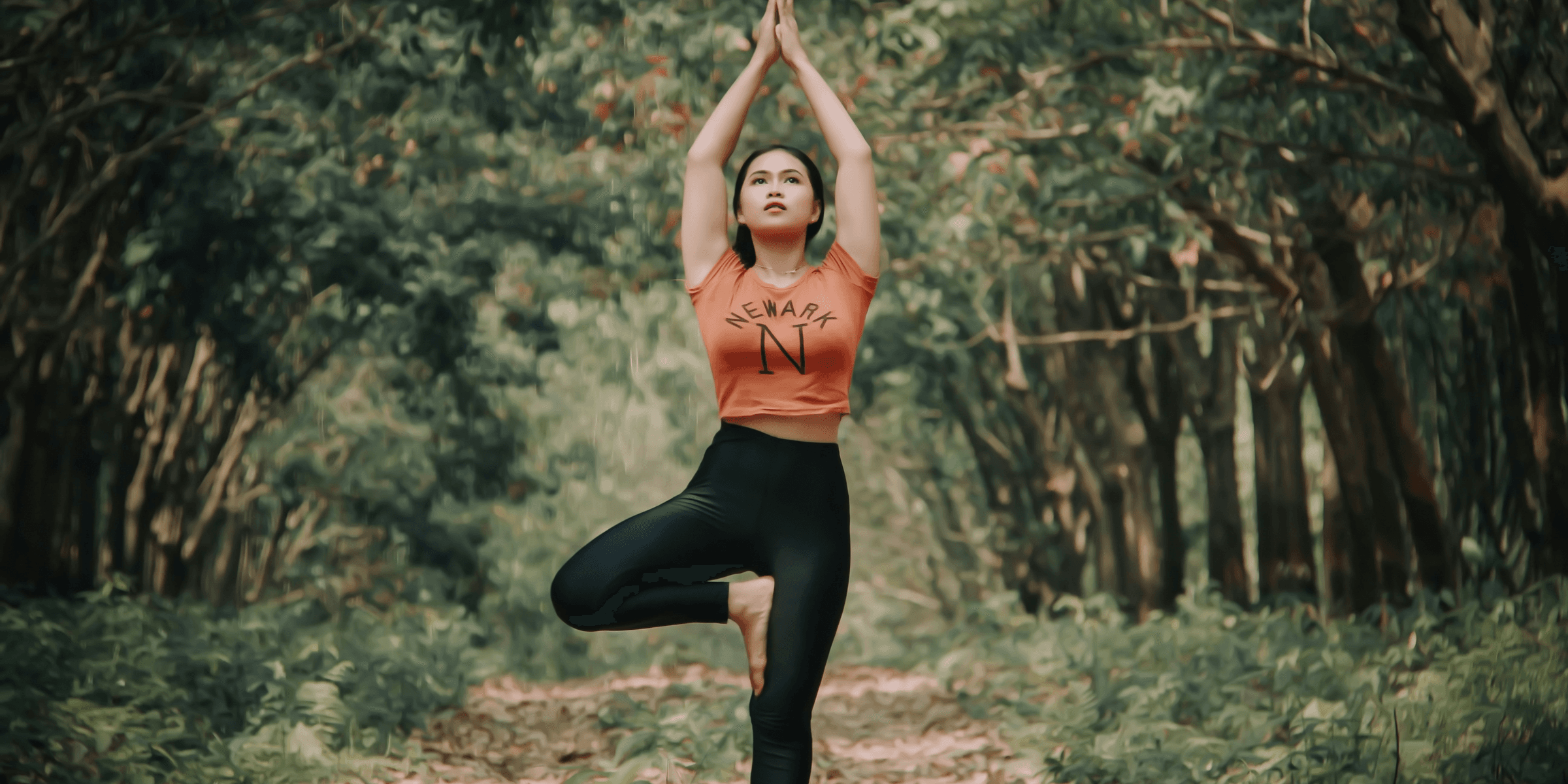 woman doing yoga near trees.
