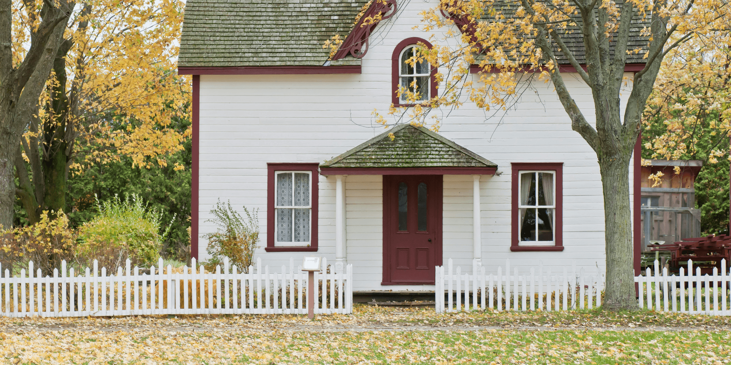 white house under maple trees.