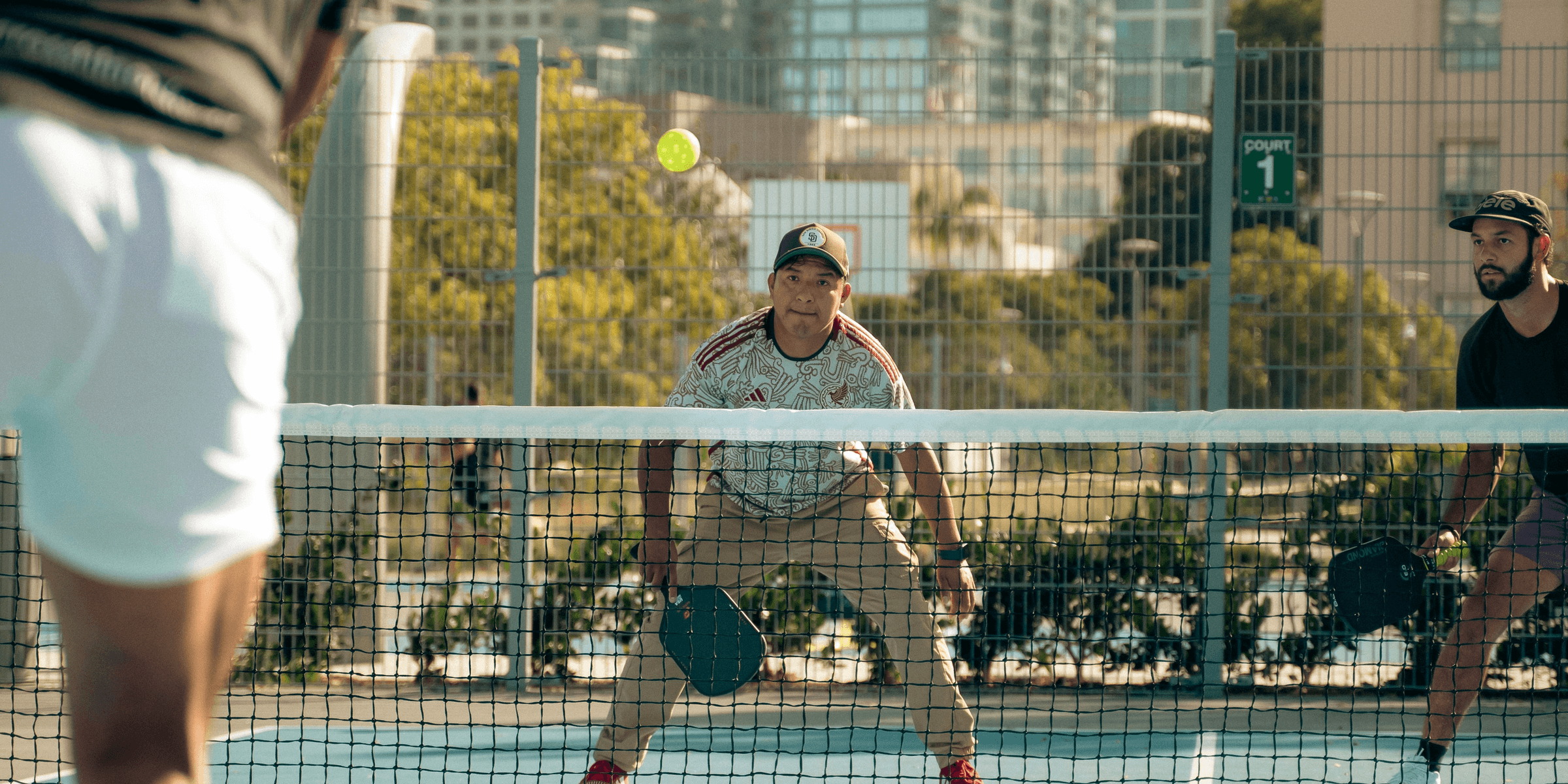 A group of men playing a game of tennis.