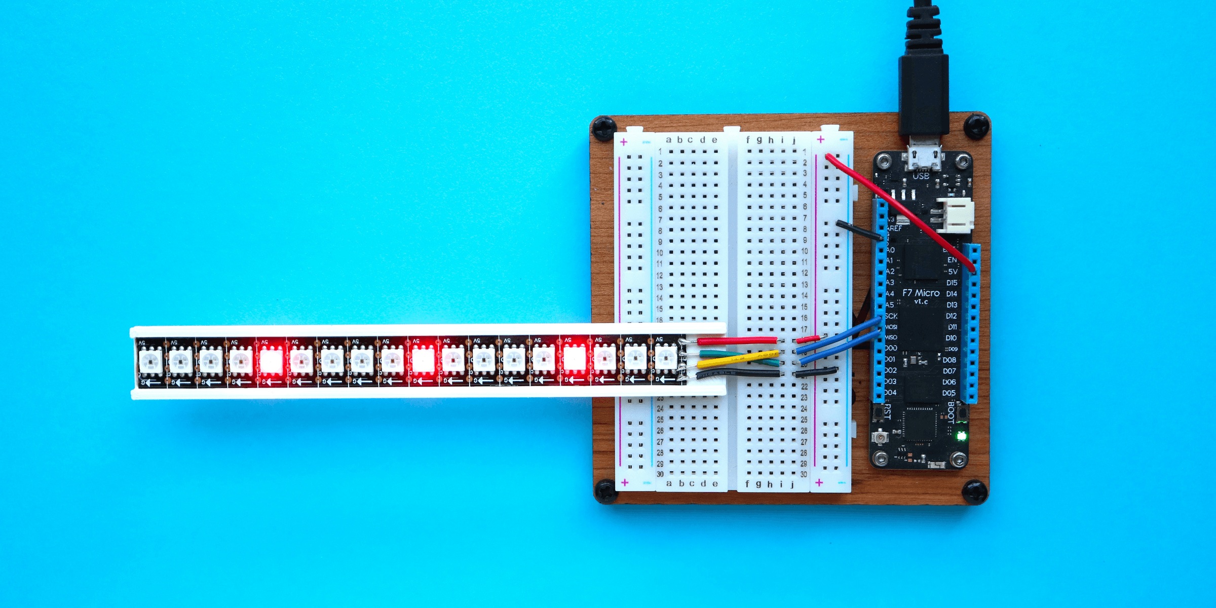 a breadboard with a thermometer and a soldering tool.
