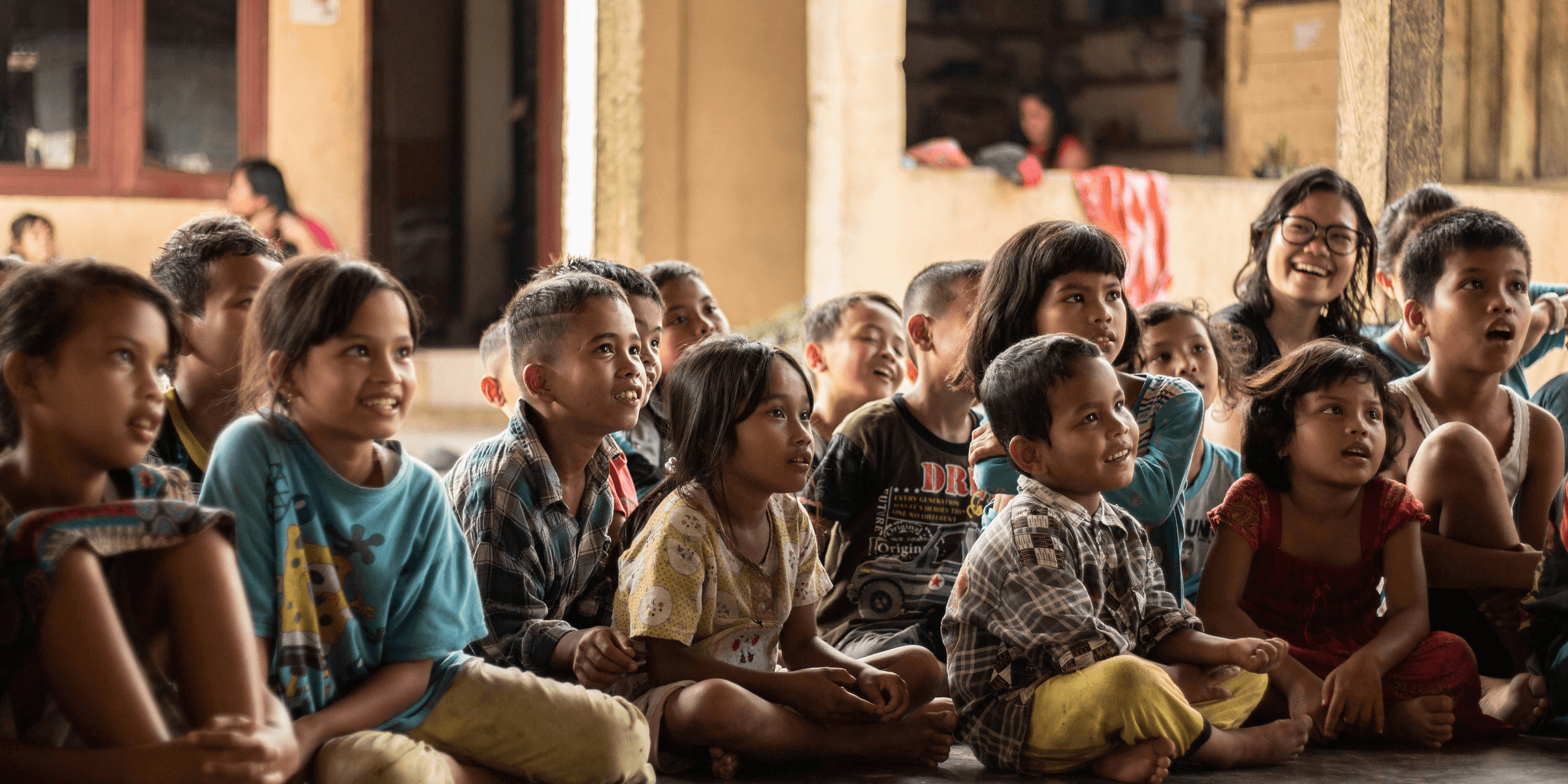 group of childrens sitting on ground.