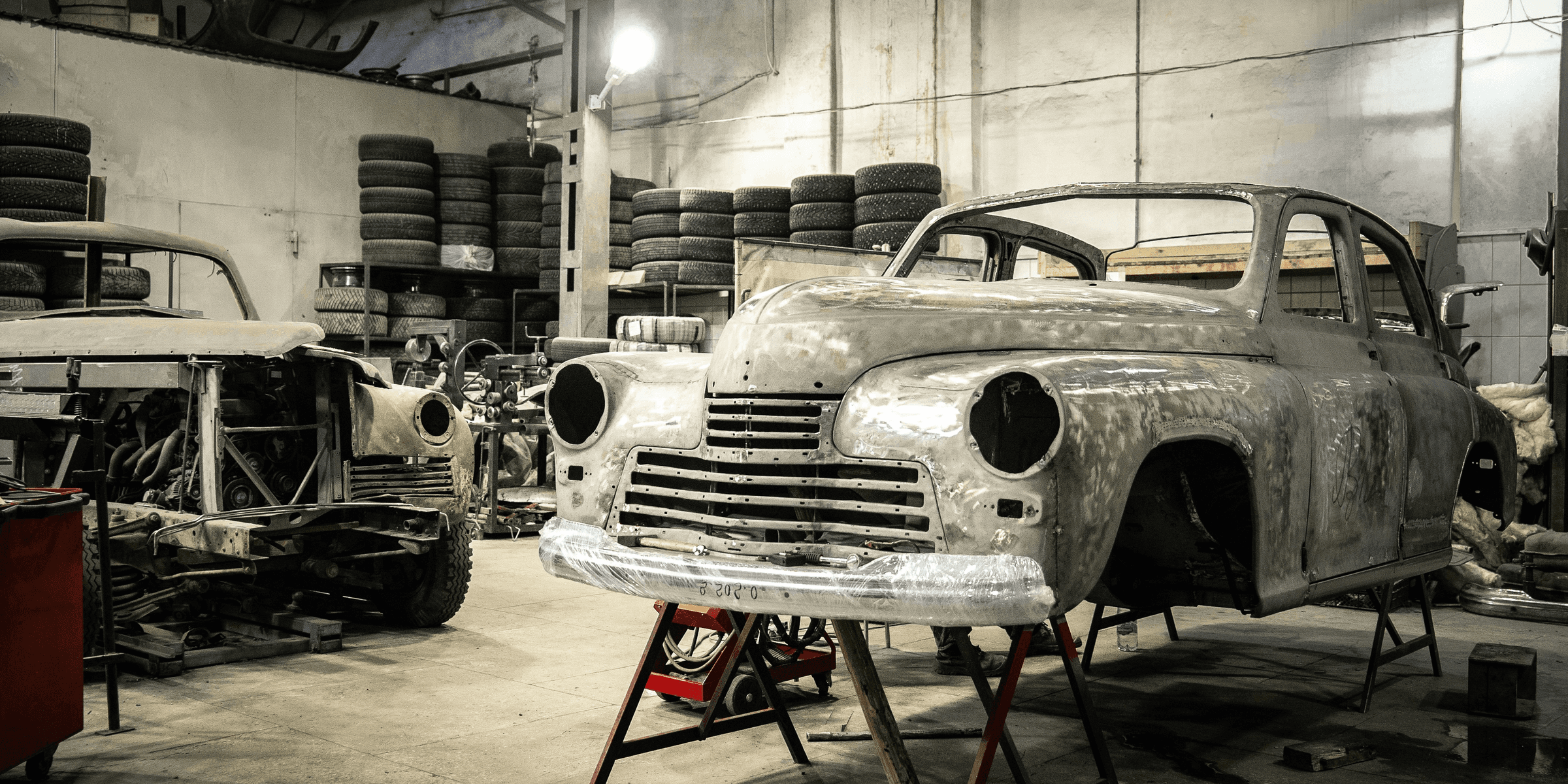 white vintage car in garage.