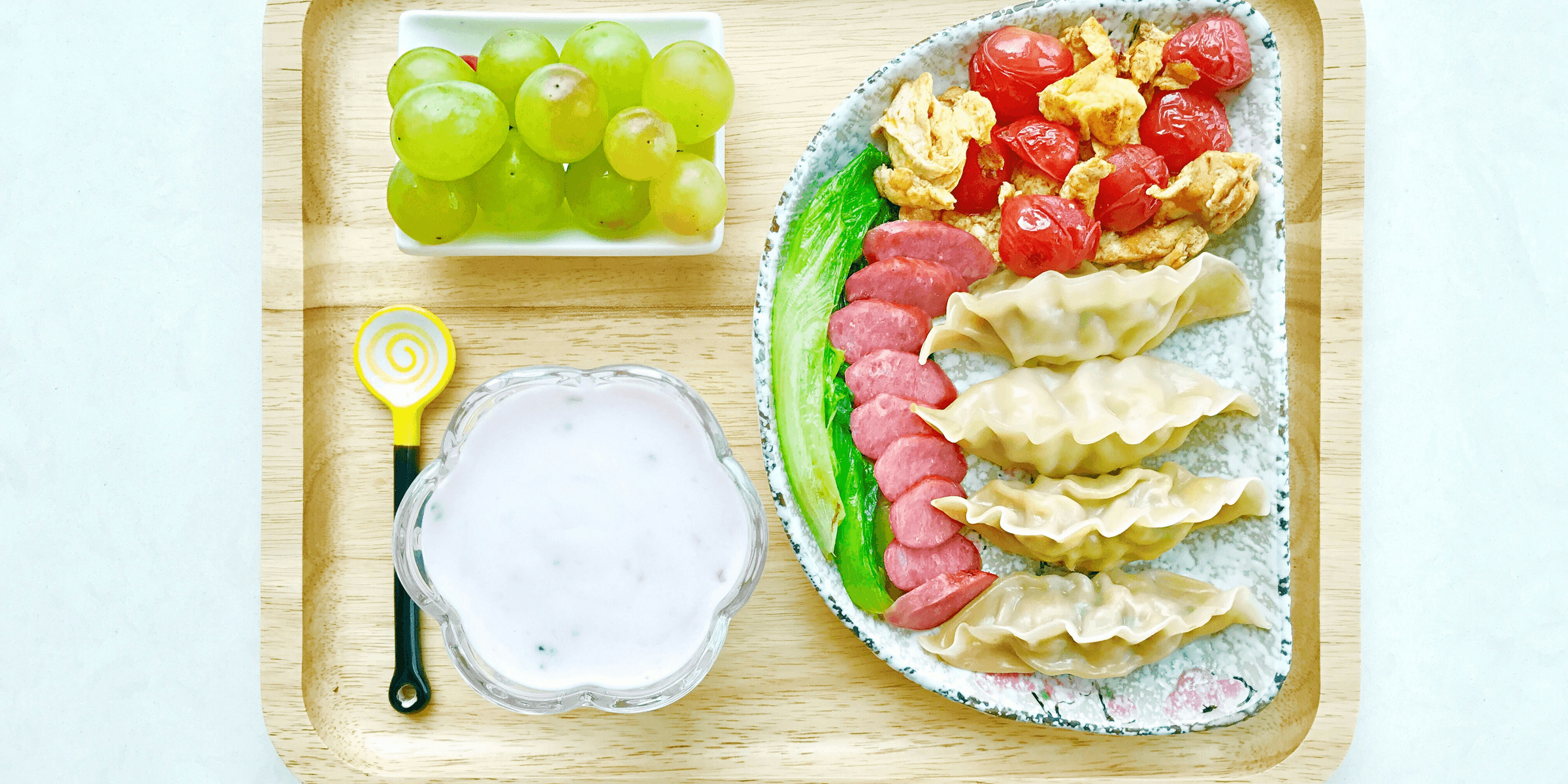 food on ceramic plates on square wooden tray