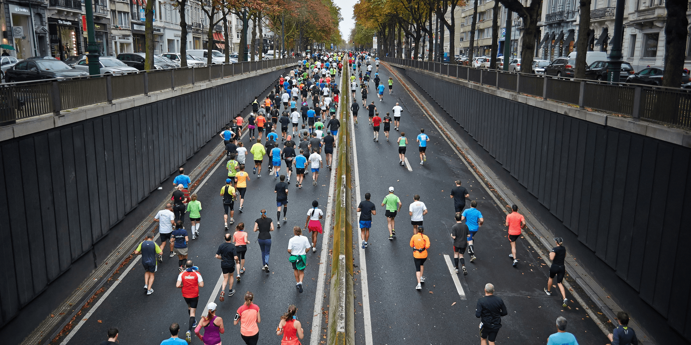 people running on road during daytime.