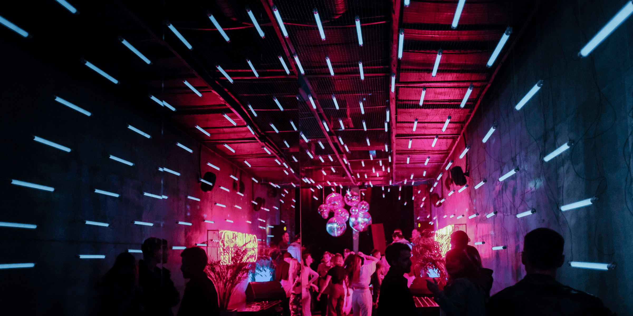 a group of people standing around in a room.