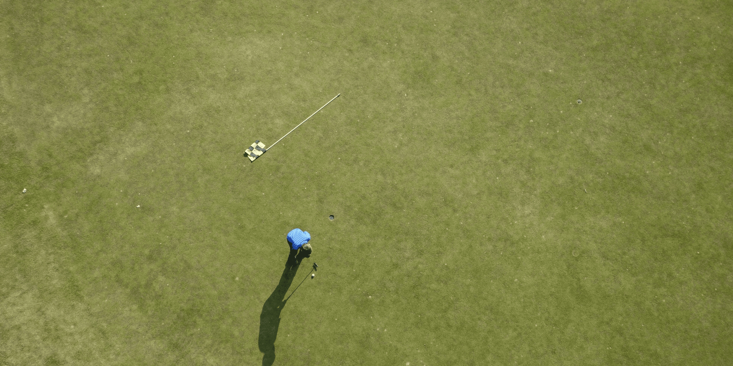 aerial photo of man playing golf.