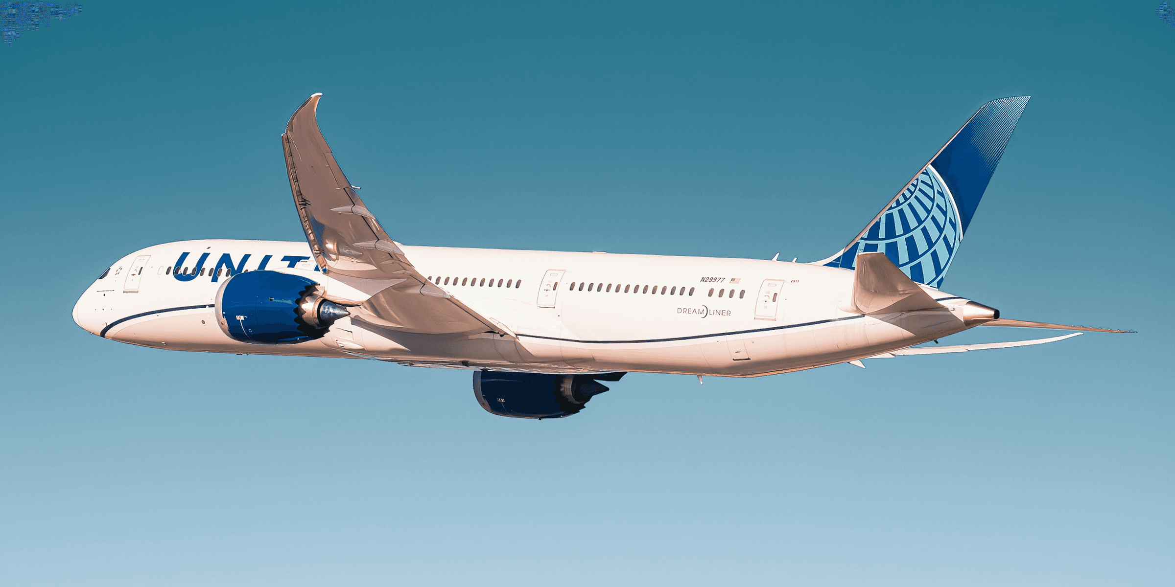 white and blue passenger plane in flight.