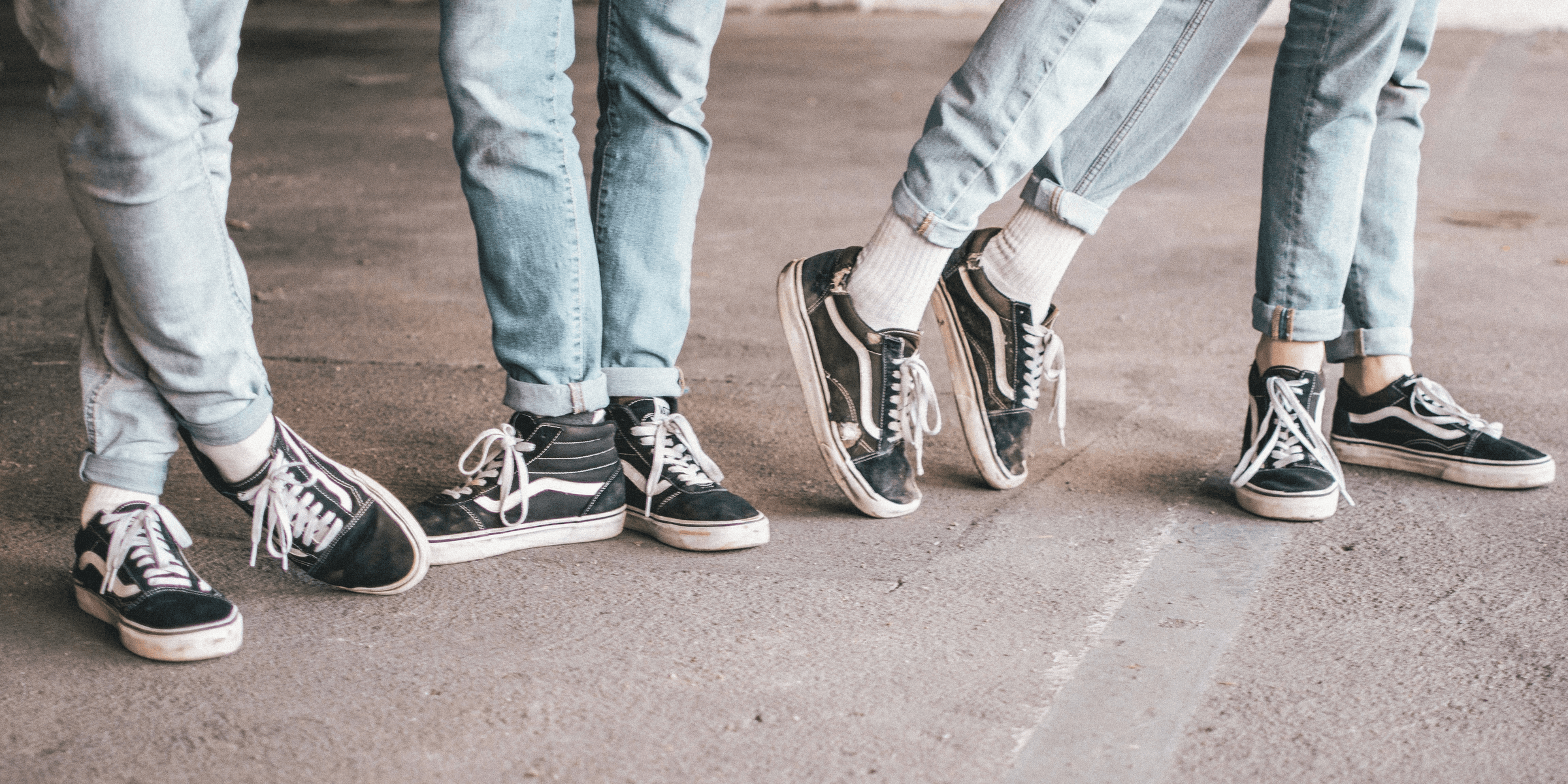 people wearing black Vans Old Skool.