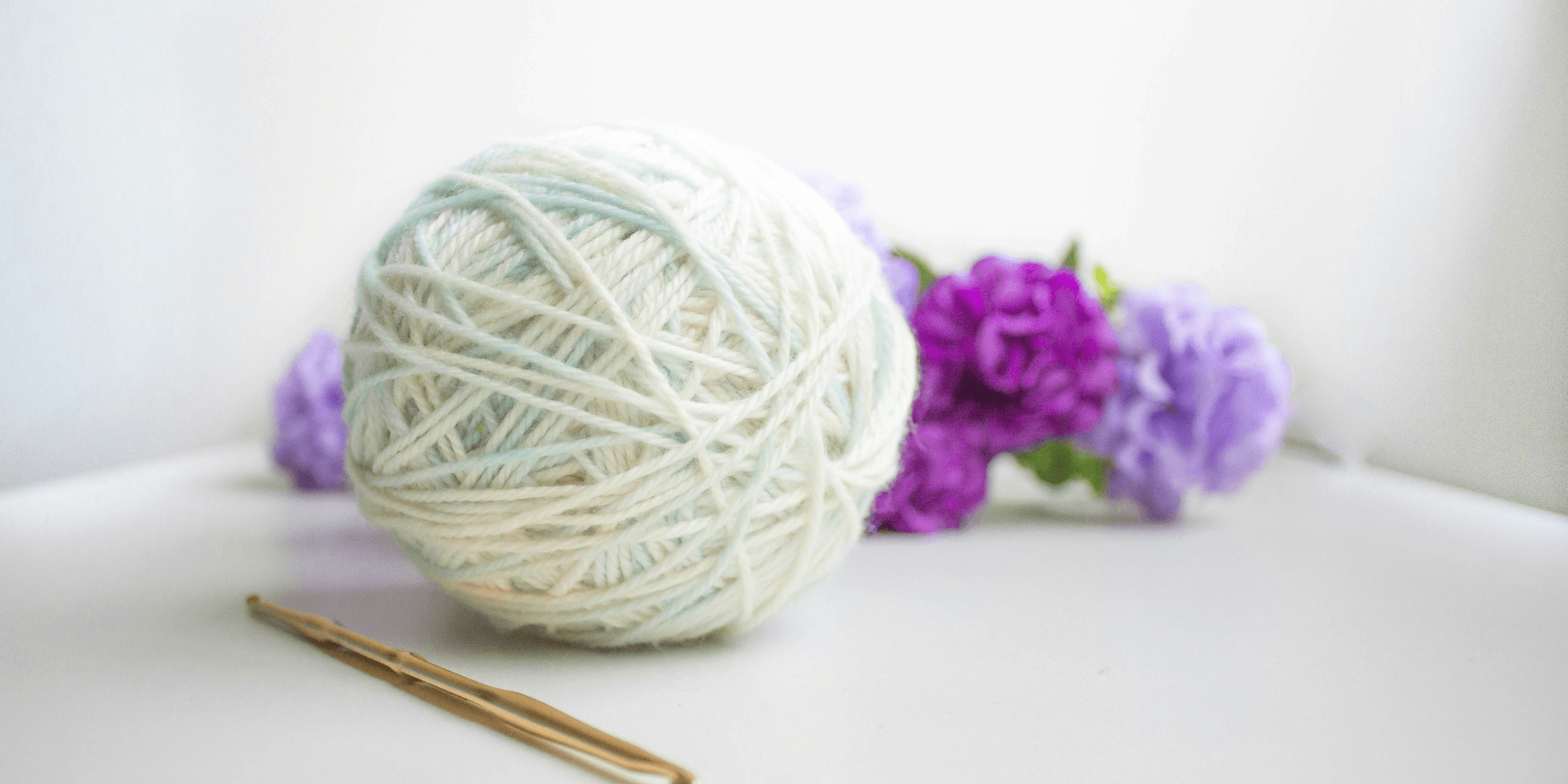 green and purple yarn ball