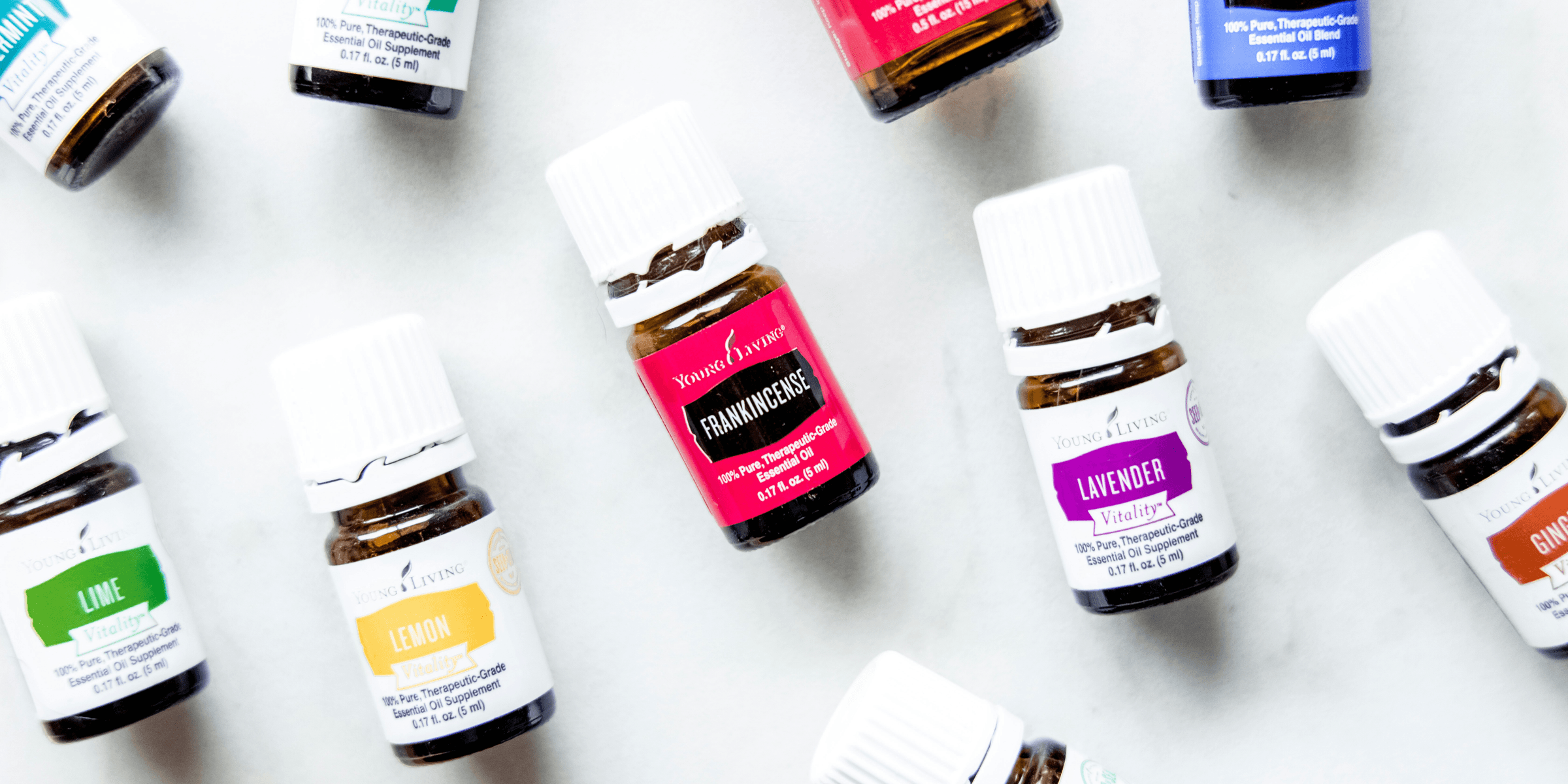 a group of bottles of essential oils on a table.