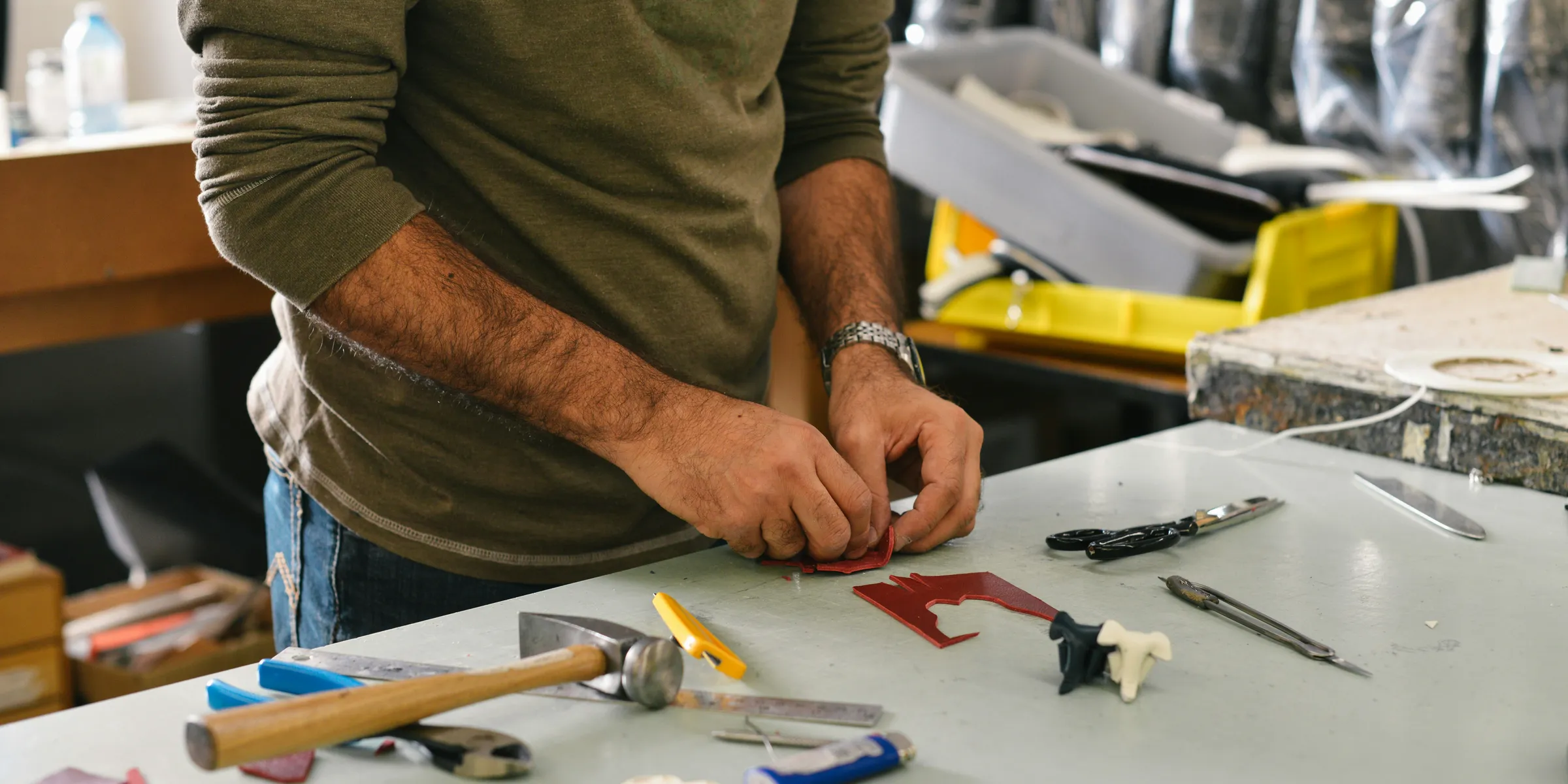 man holding tool in front of table
